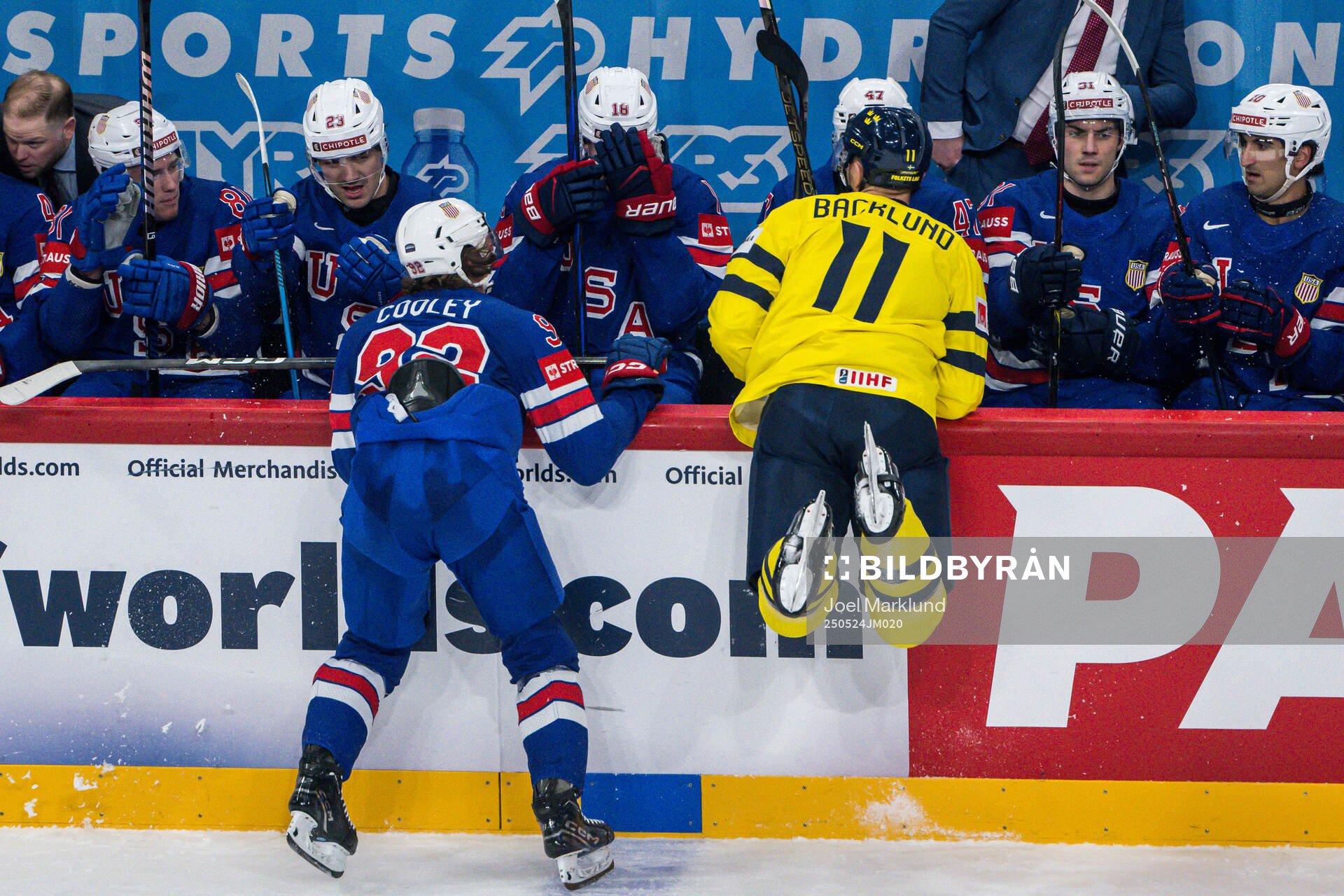Logan Cooley of USA and Mikael Backlund of Sweden