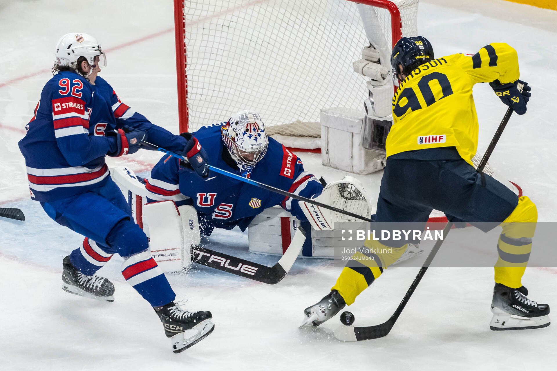 Logan Cooley and goaltender Jeremy Swayman of USA against