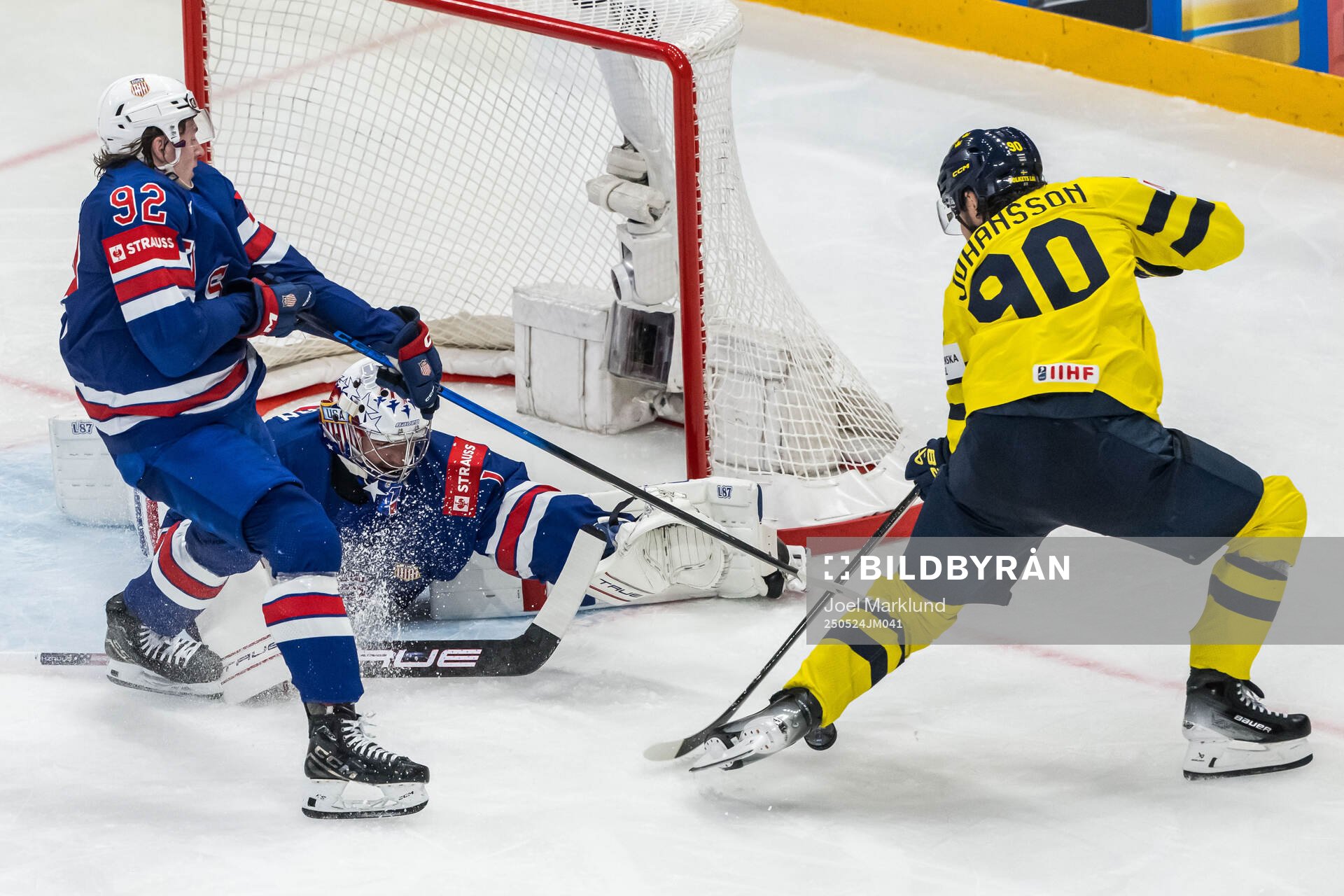 Logan Cooley and goaltender Jeremy Swayman of USA against