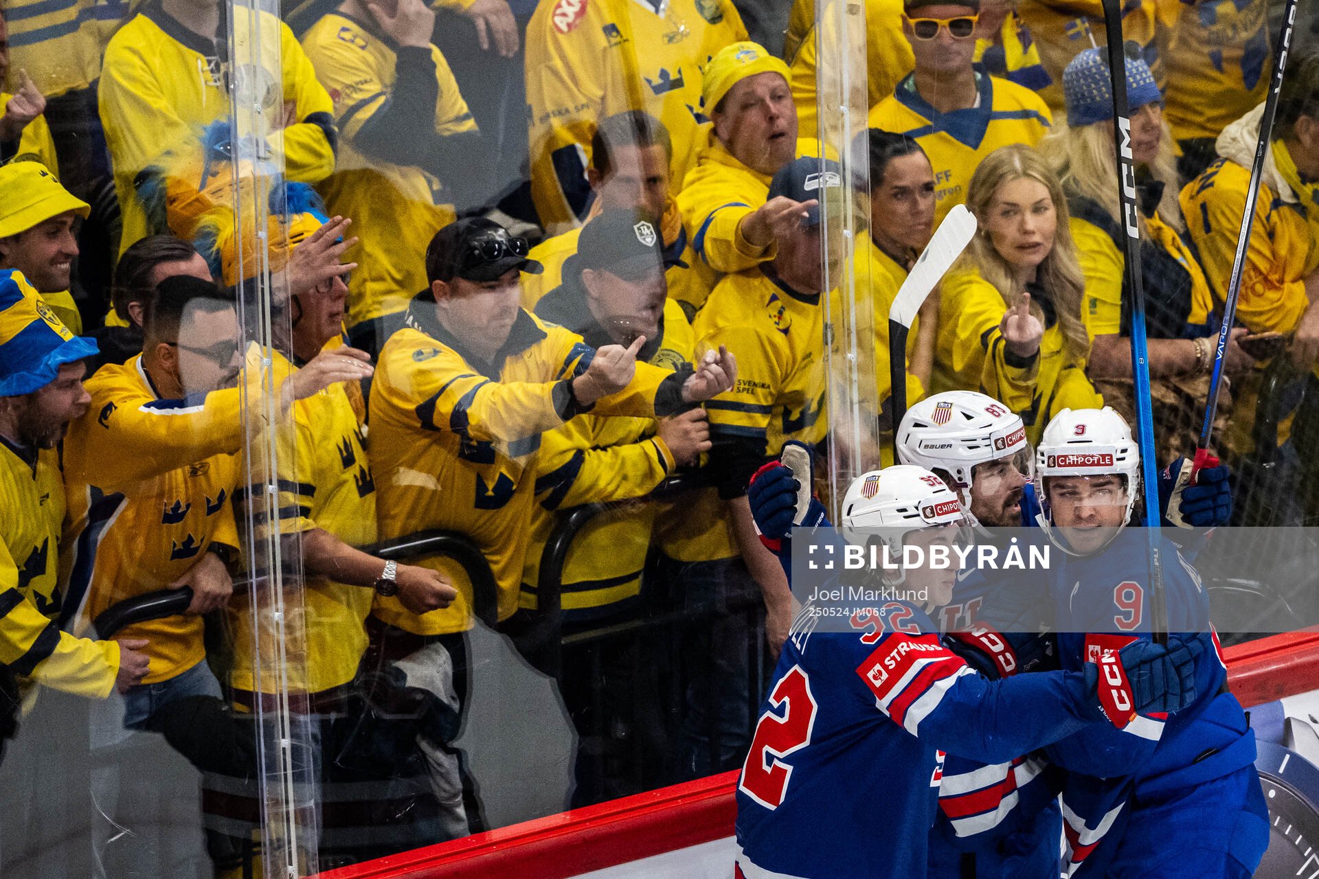 Swedish fans show their middle fingers and shout towards