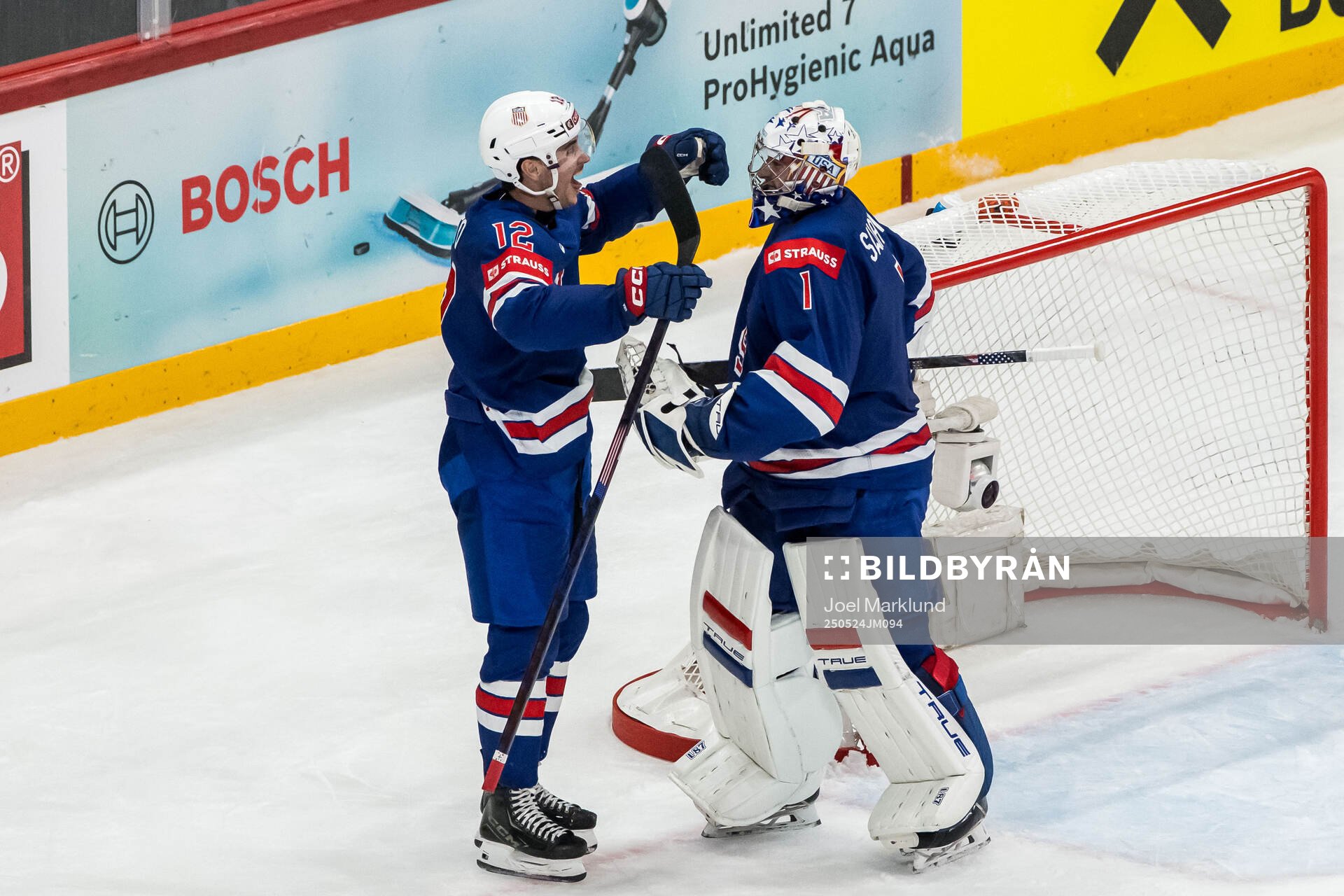 Shane Pinto and goaltender Jeremy Swayman of USA celebrate