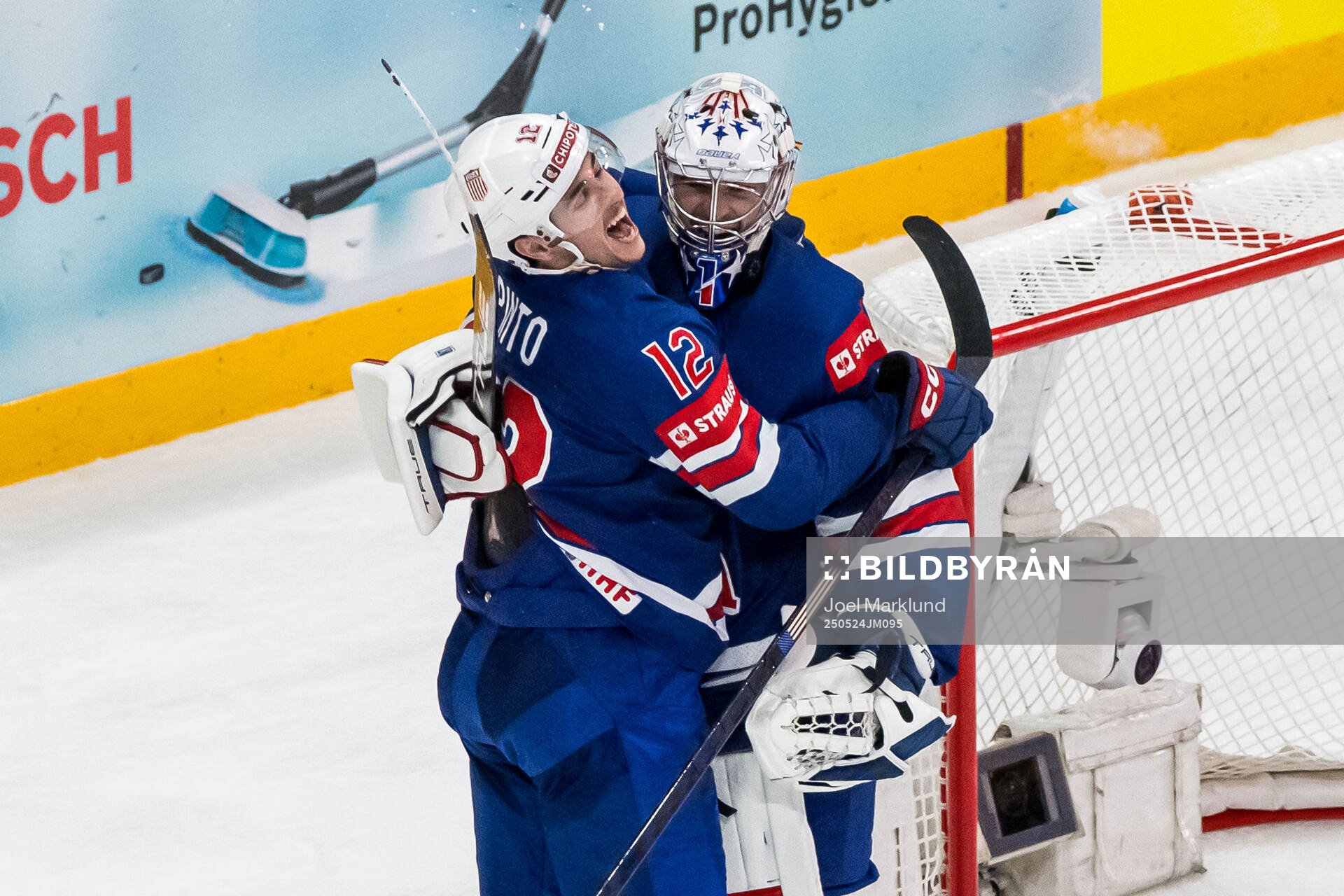 Shane Pinto and goaltender Jeremy Swayman of USA celebrate