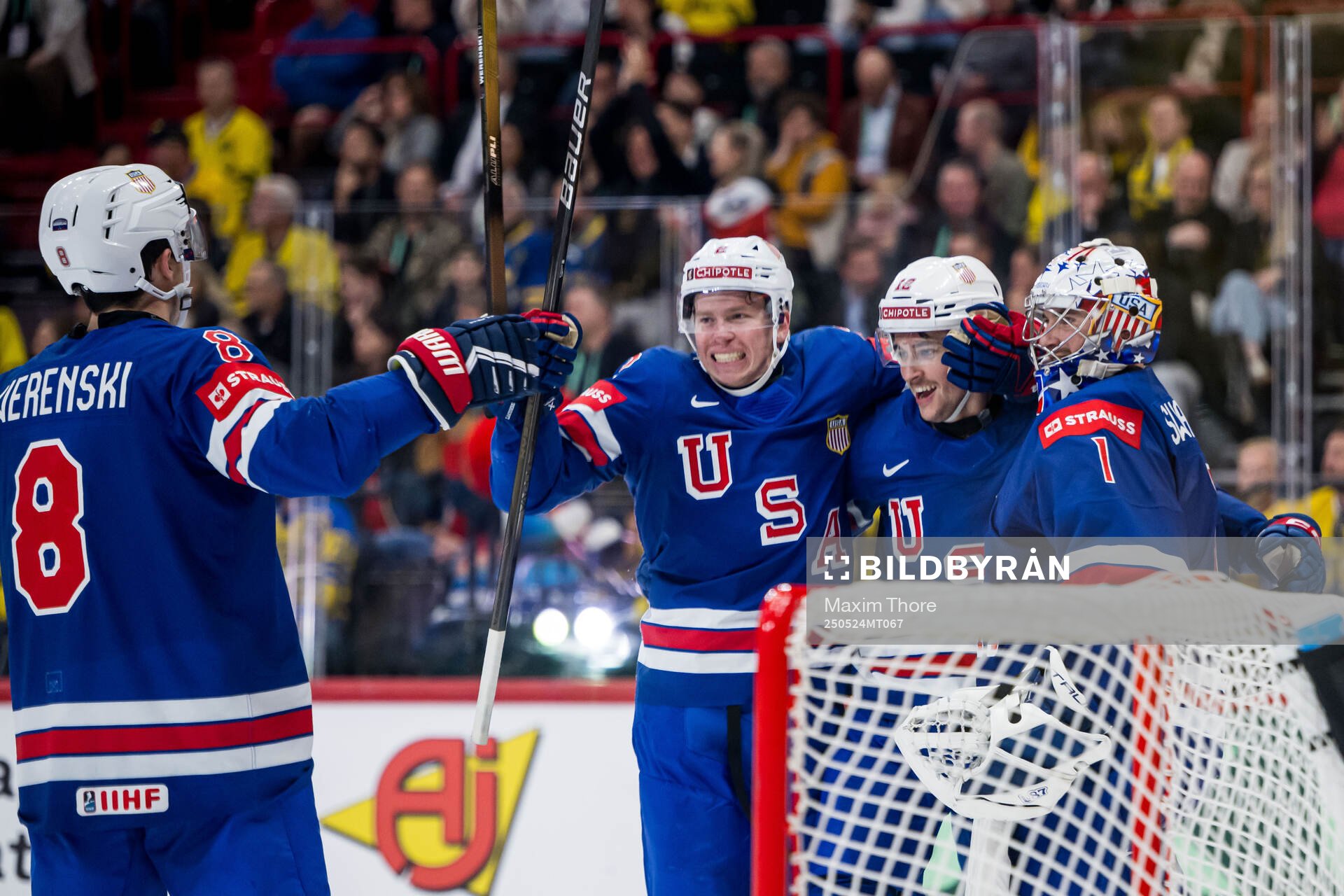 Shane Pinto of USA celebrates with Zach Werenski and