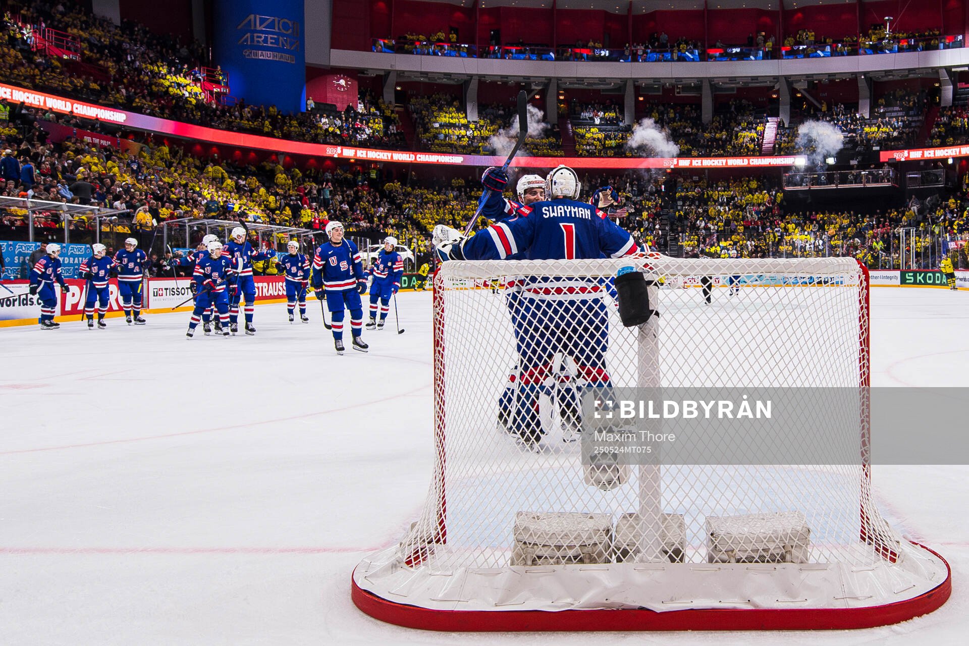 Goaltender Jeremy Swayman of USA celebrate with teammates