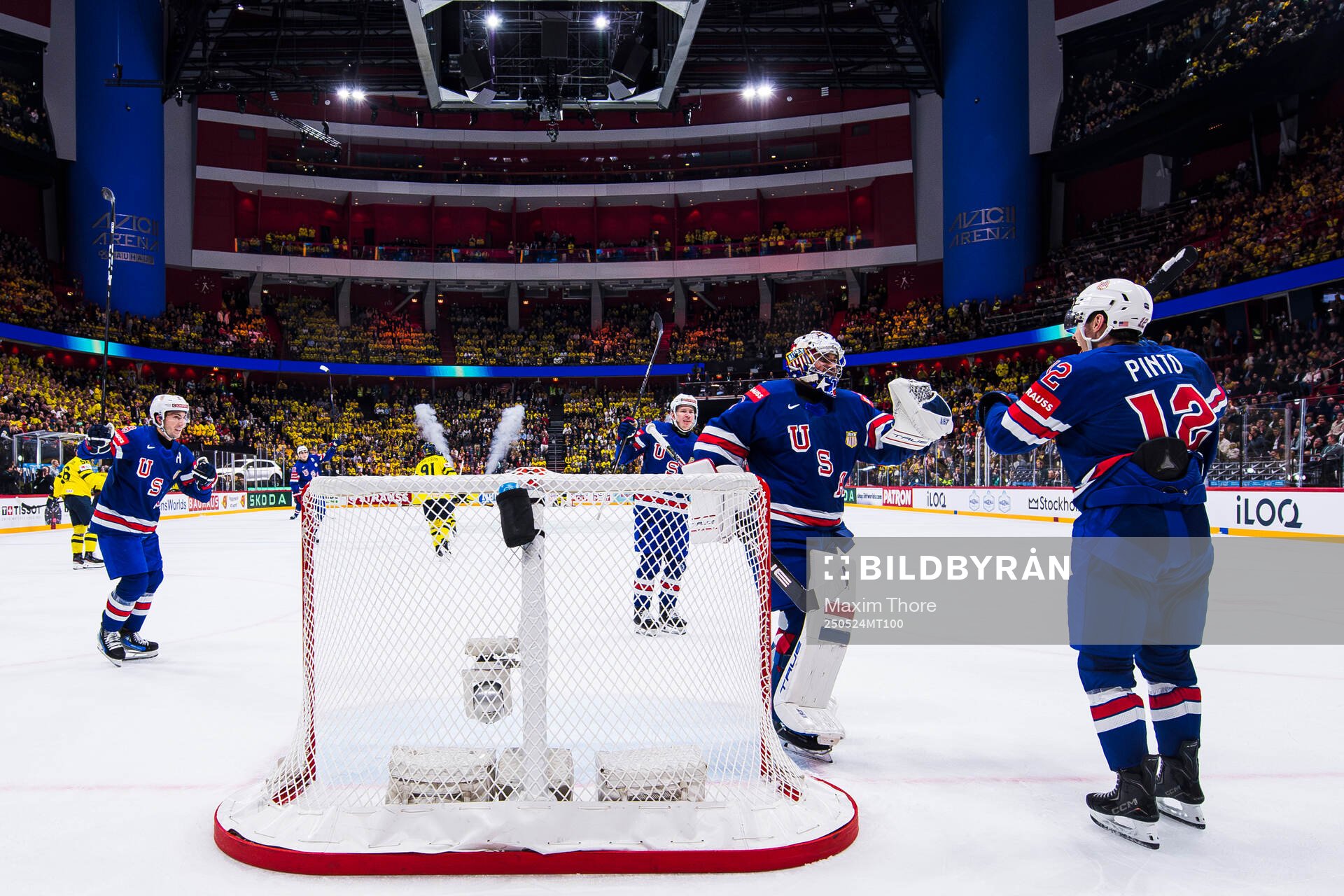 Goaltender Jeremy Swayman and Shane Pinto of USA celebrate