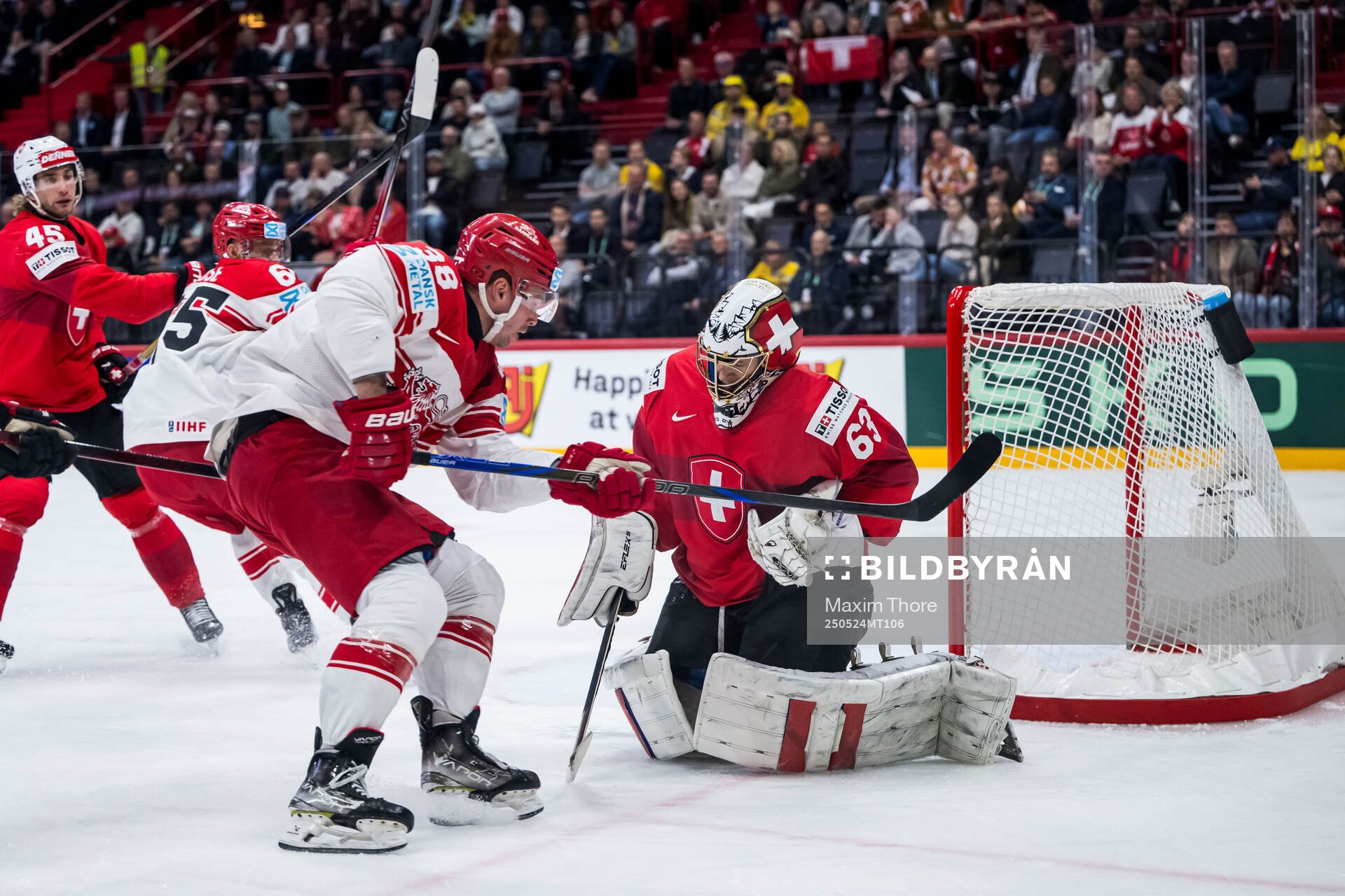 Morten Poulsen of Denmark and goaltender Leonardo Genoni of