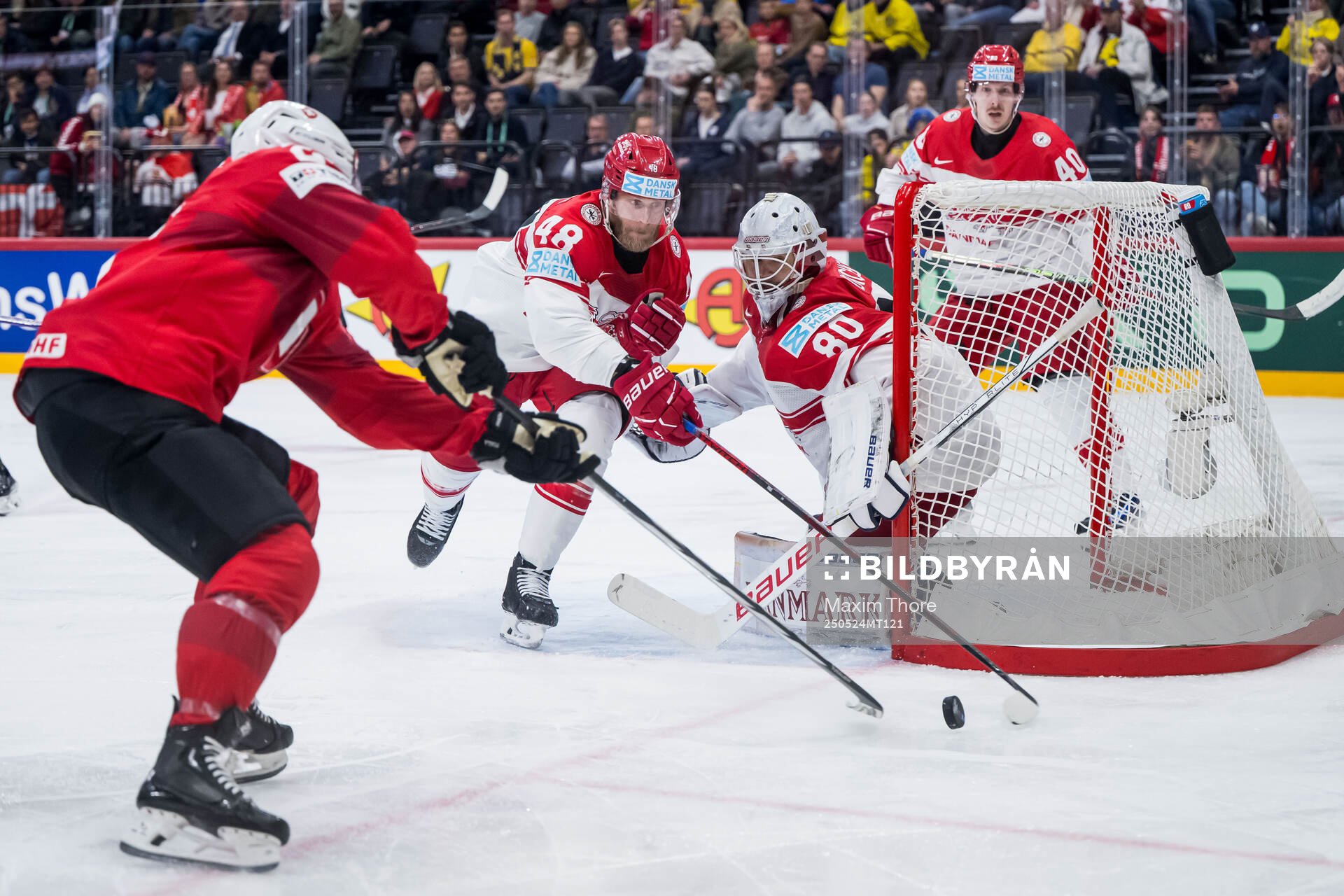 Nicholas B Jensen and goaltender Frederik Dichow of Denmark