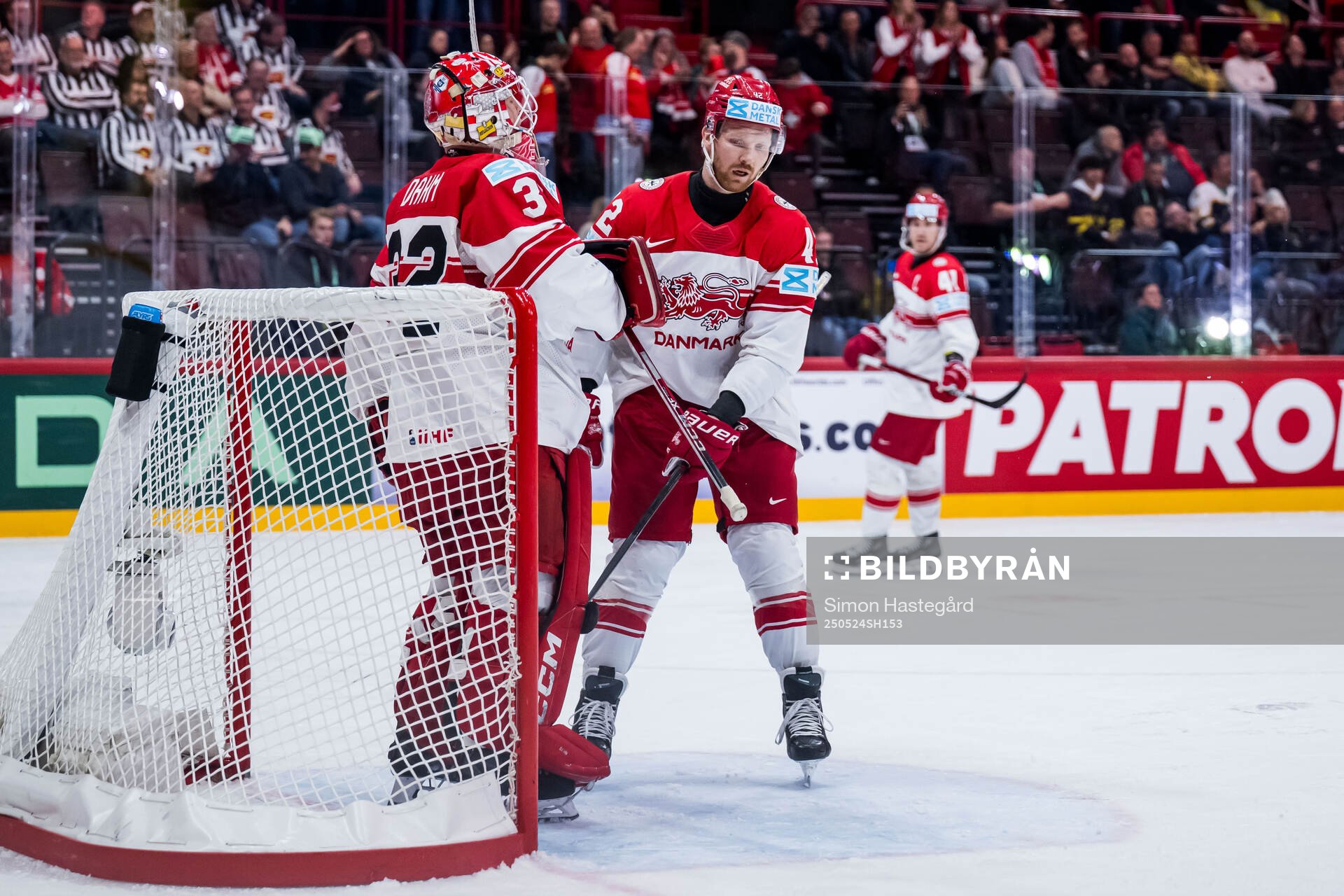 Goaltender Sebastian Dahm and Phillip Bruggisser of Denmark