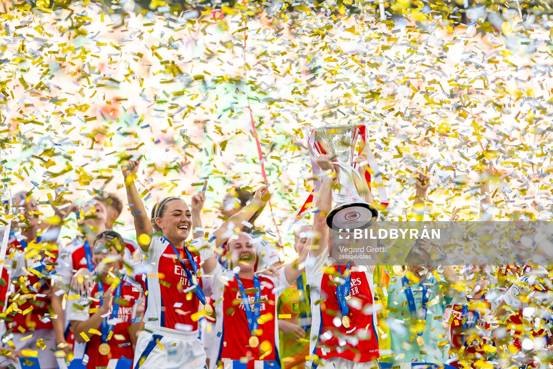 Katie McCabe, Kim Little and players of Arsenal celebrate with the trophy after the UEFA Women's Champions League final match between Arsenal and Barcelona on May 24, 2025 in Lisbon.