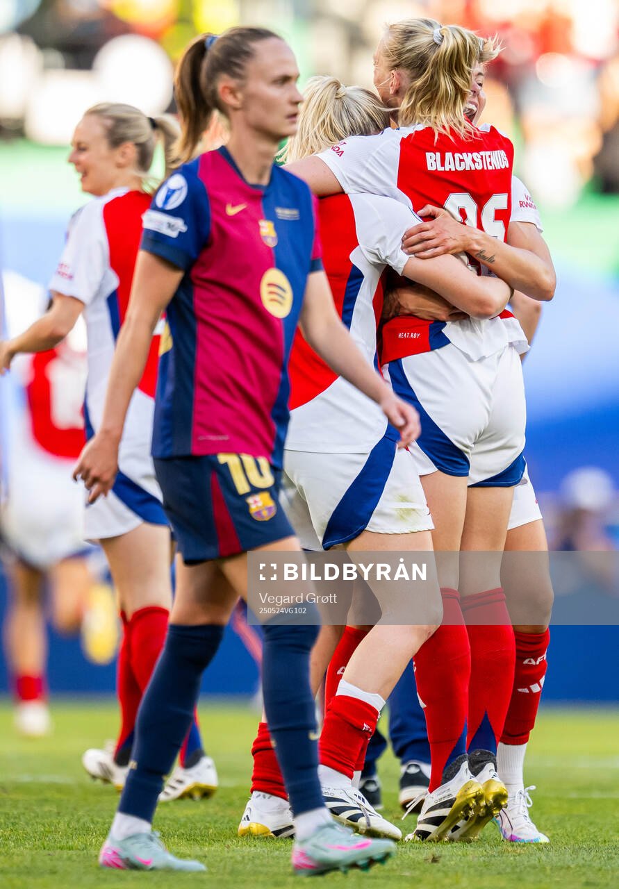 Stina Blackstenius and Lina Hurtig of Arsenal celebrate while Caroline Graham Hansen of Barcelona looks dejected after the UEFA Women's Champions League final match between Arsenal and Barcelona on May 24, 2025 in Lisbon.