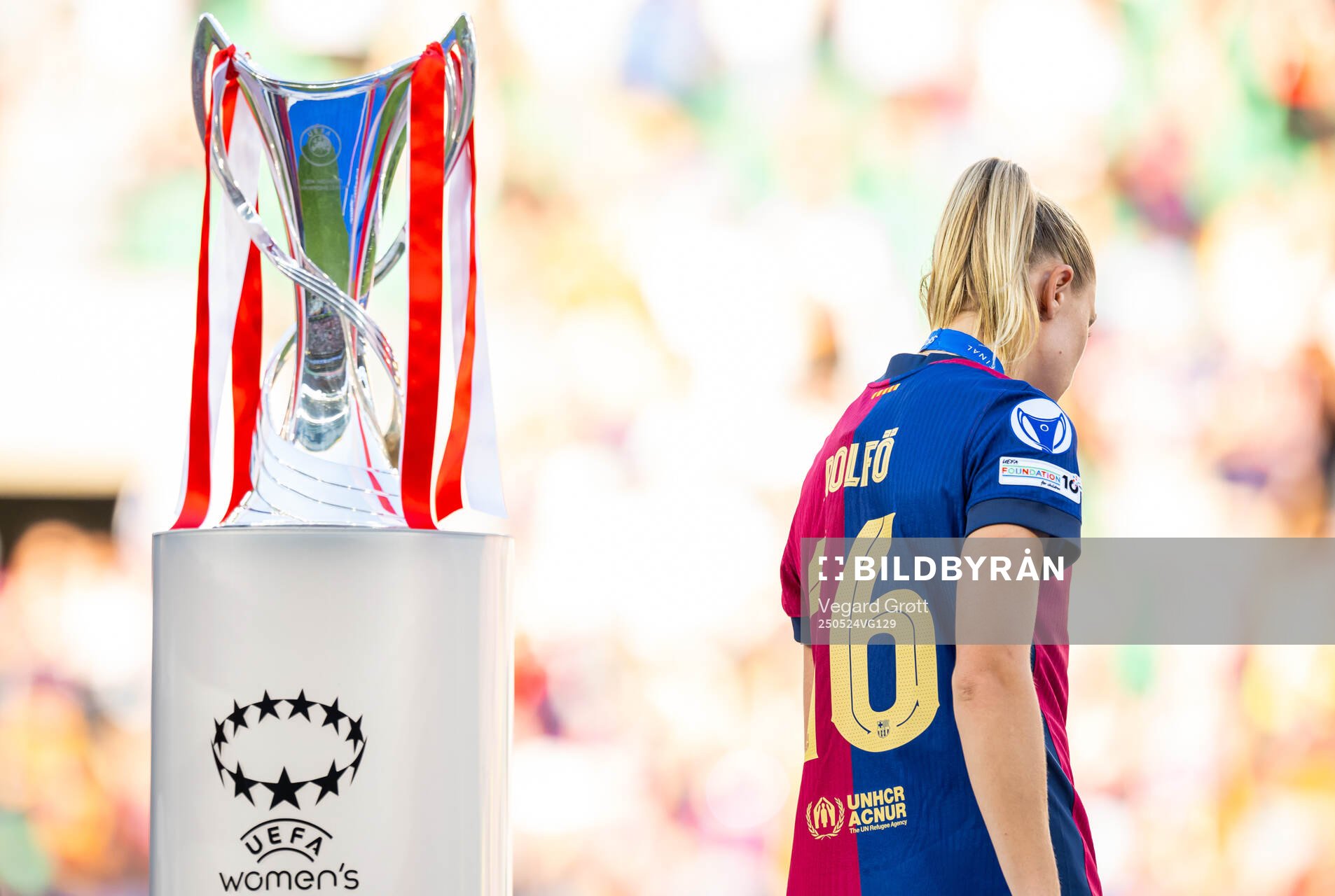 Fridolina Rolfö of Barcelona walks past the trophy
