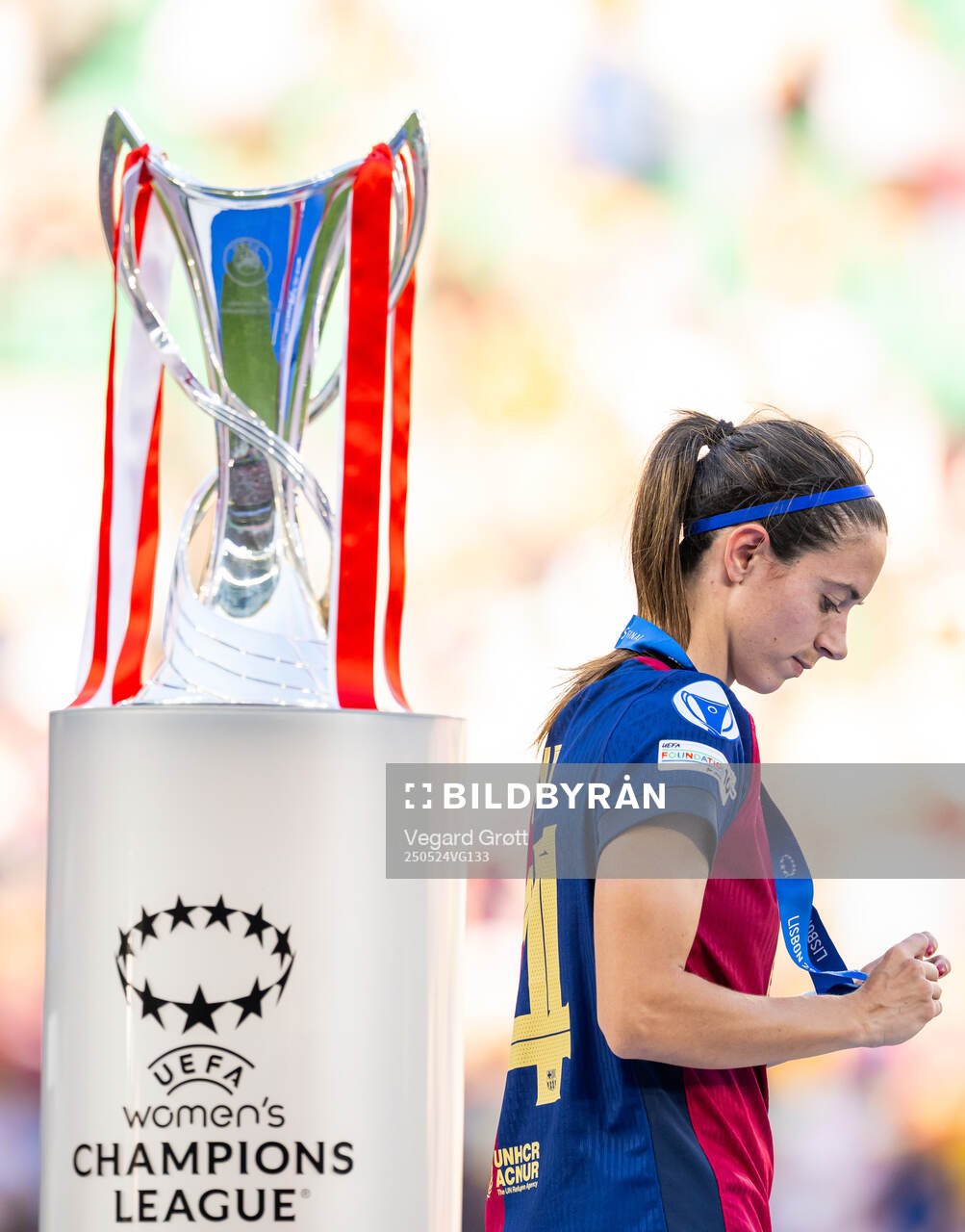 Aitana Bonmati of Barcelona walks past the trophy