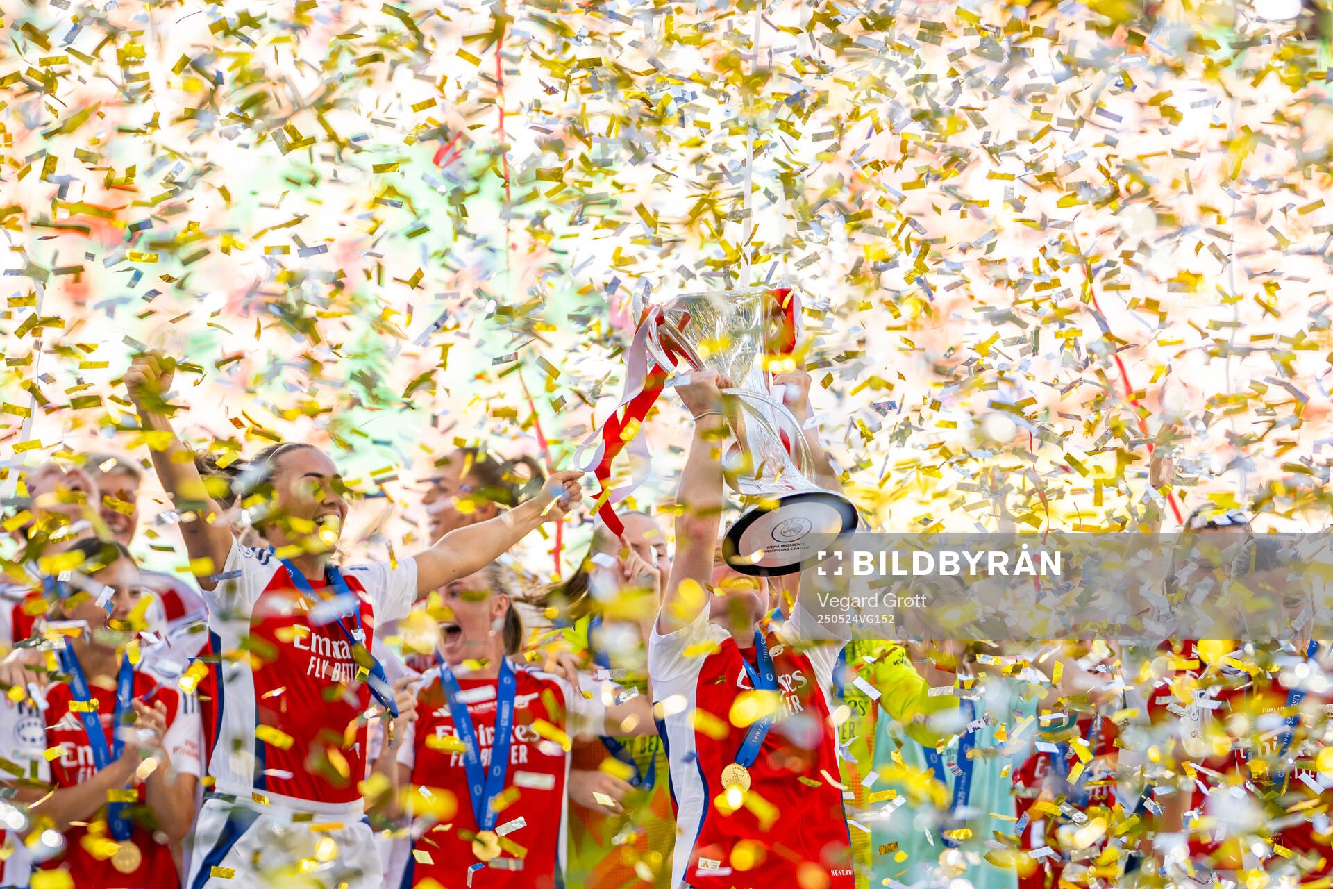 Katie McCabe, Kim Little and players of Arsenal celebrate with the trophy after the UEFA Women's Champions League final match between Arsenal and Barcelona on May 24, 2025 in Lisbon.