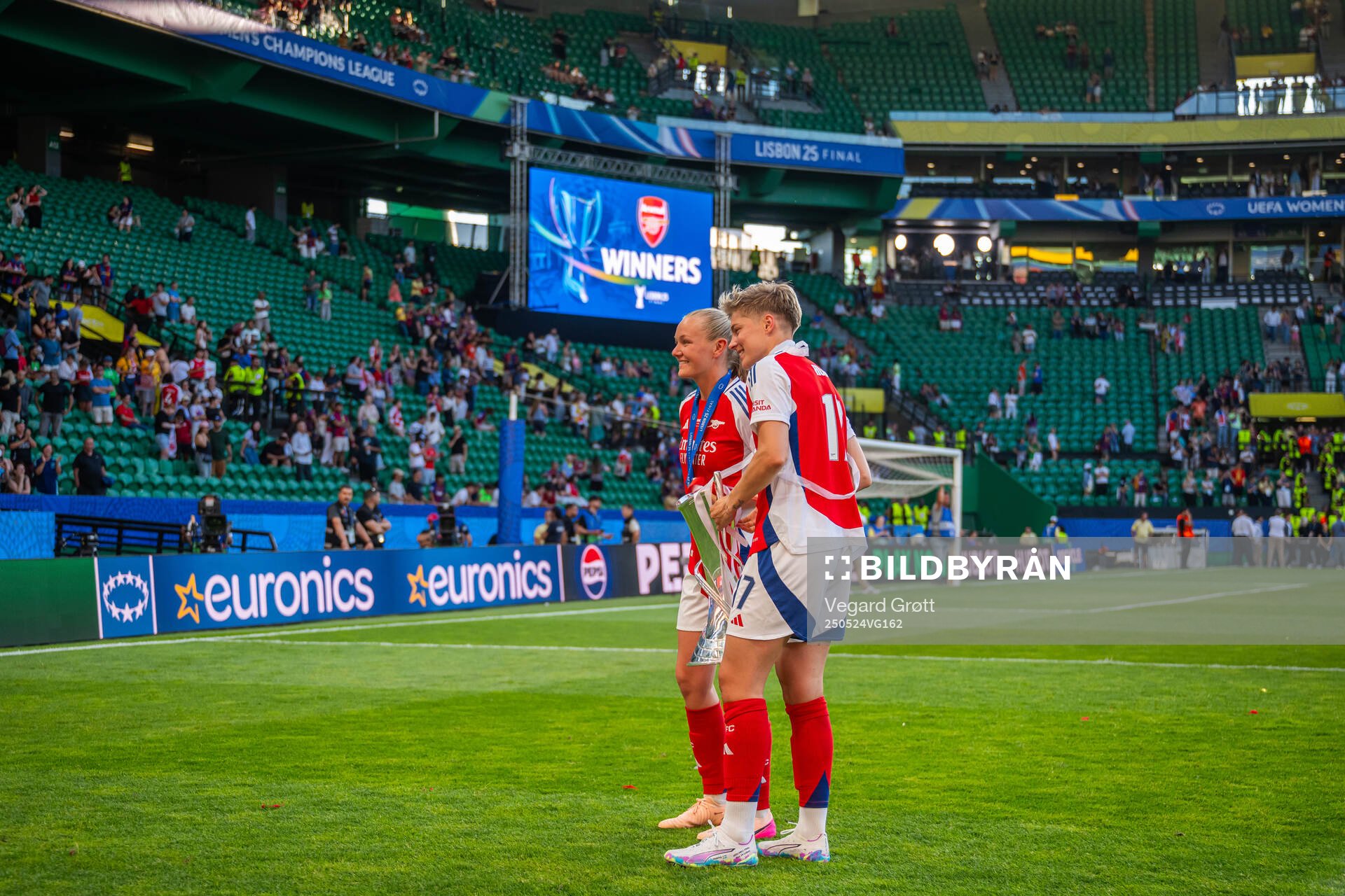 Frida Maanum and Lina Hurtig of Arsenal celebrate with the trophy after the UEFA Women's Champions League final match between Arsenal and Barcelona on May 24, 2025 in Lisbon.