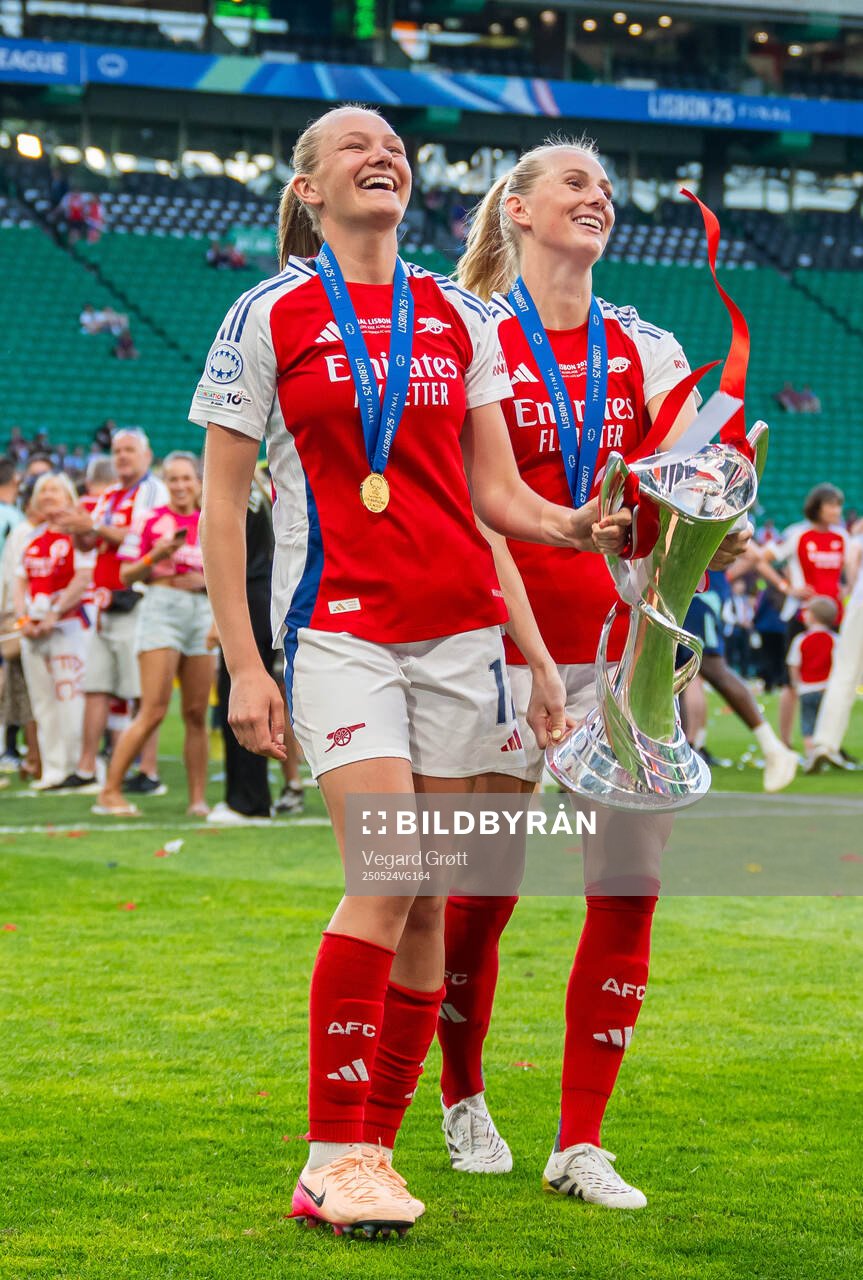Frida Maanum and Stina Blackstenius of Arsenal celebrate with the trophy after the UEFA Women's Champions League final match between Arsenal and Barcelona on May 24, 2025 in Lisbon.
