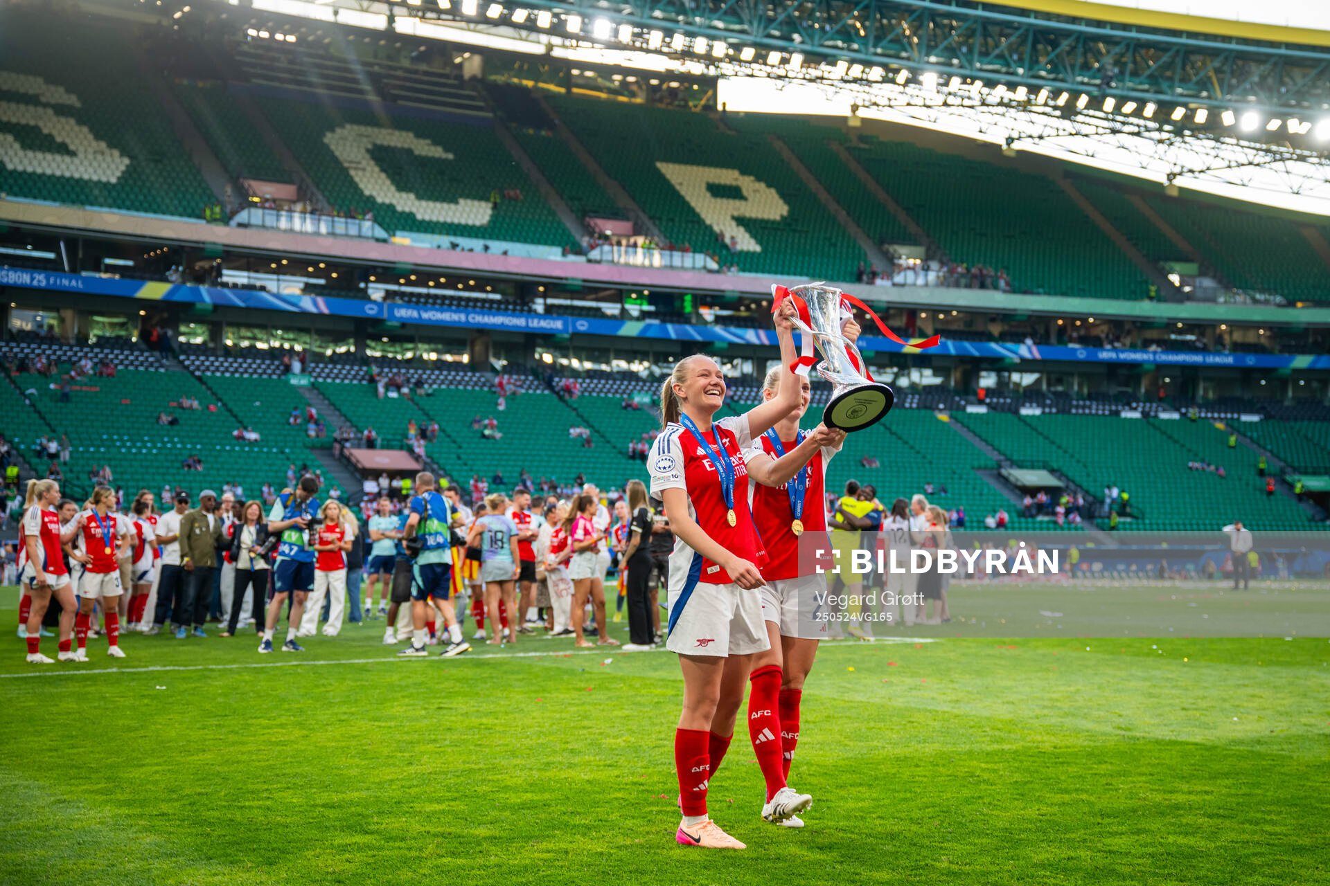 Frida Maanum and Stina Blackstenius of Arsenal celebrate with the trophy after the UEFA Women's Champions League final match between Arsenal and Barcelona on May 24, 2025 in Lisbon.