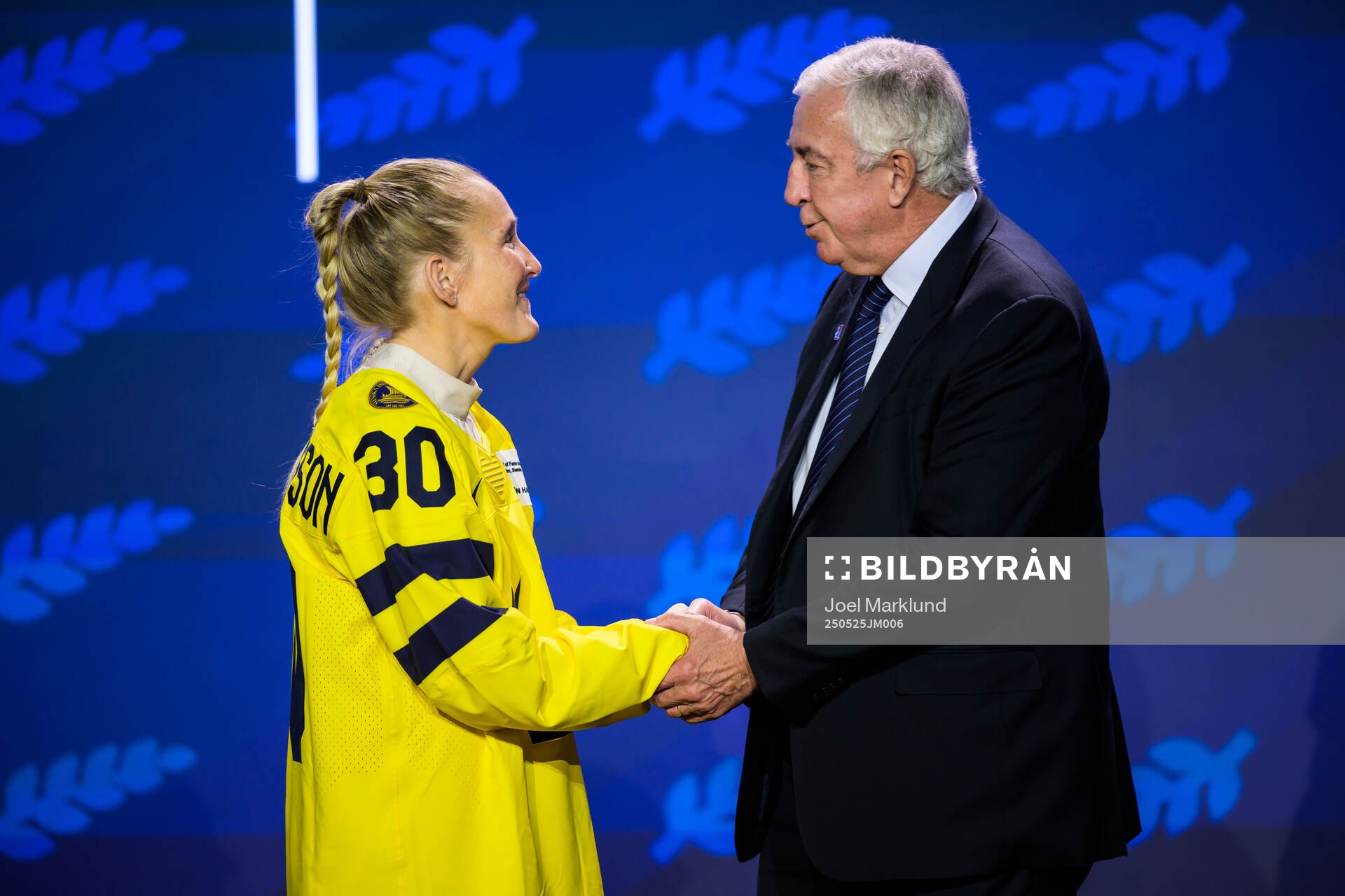Kim Martin-Hasson of Sweden and IIHF president Luc Tardif