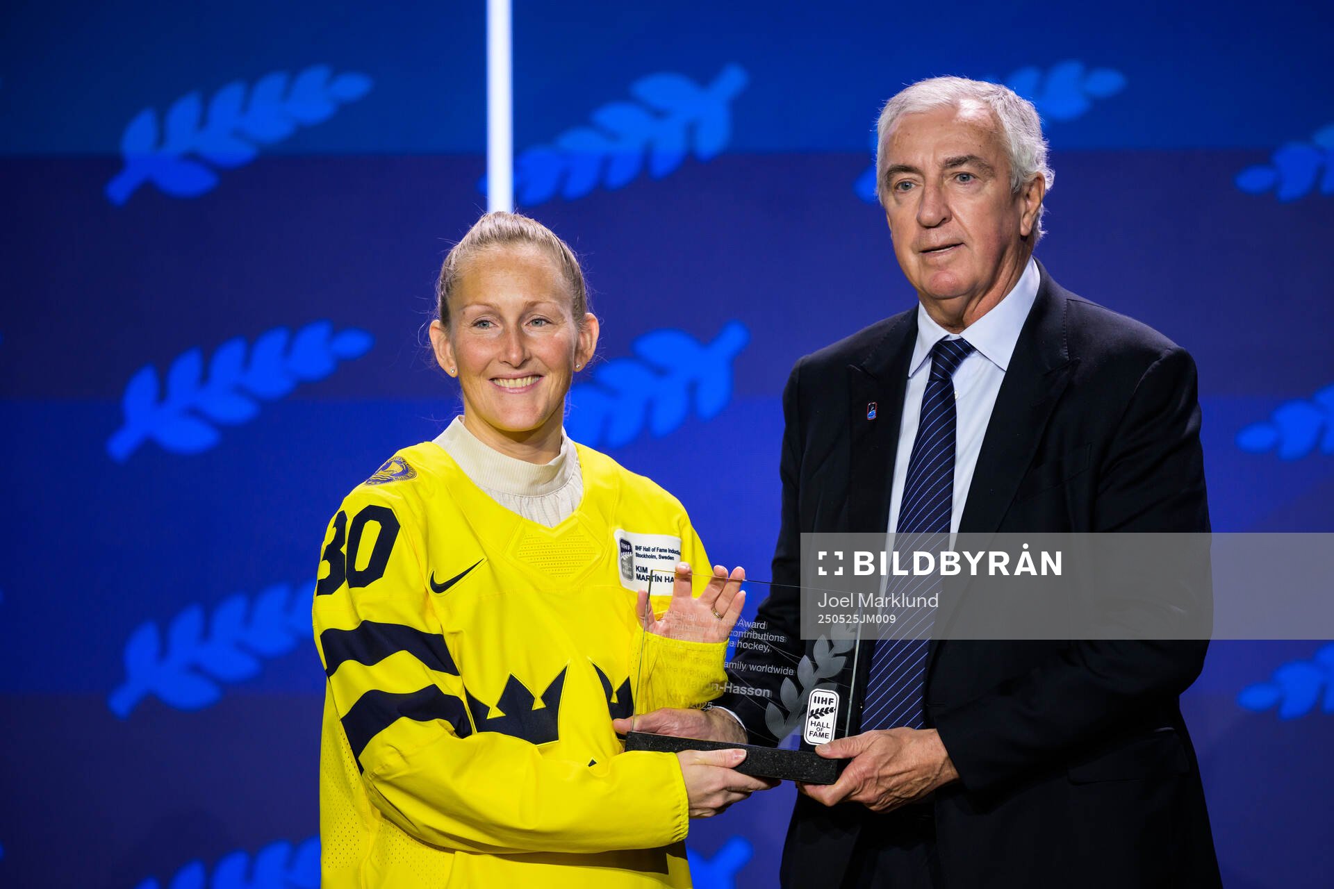 Kim Martin-Hasson of Sweden and IIHF president Luc Tardif