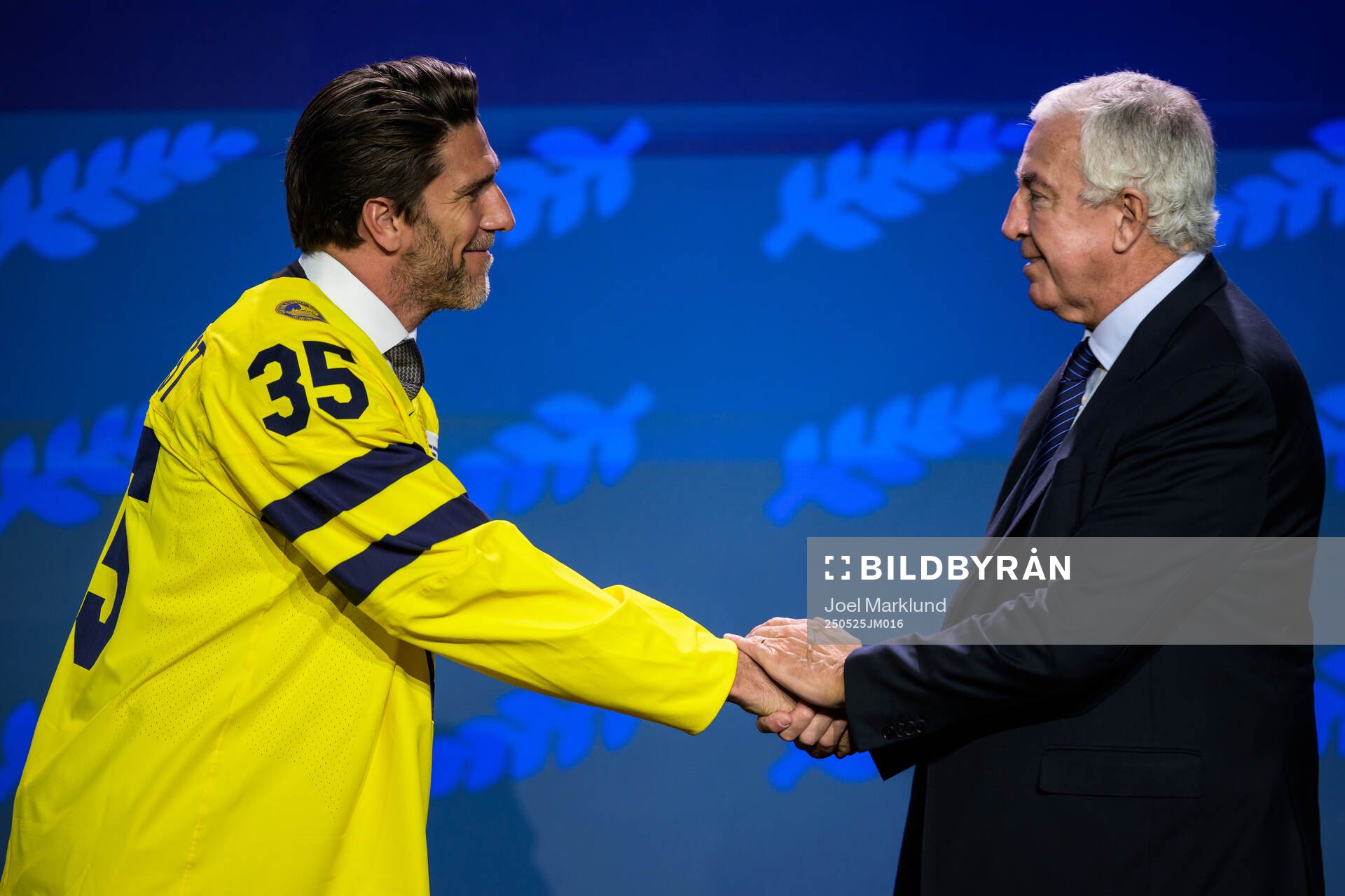 Henrik Lundqvist of Sweden and IIHF president Luc Tardif