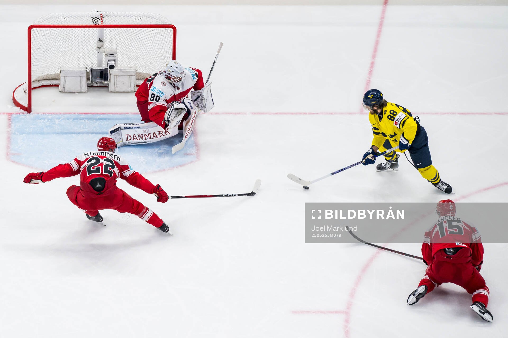 Markus Lauridsen and goaltender Frederik Dichow of Denmark