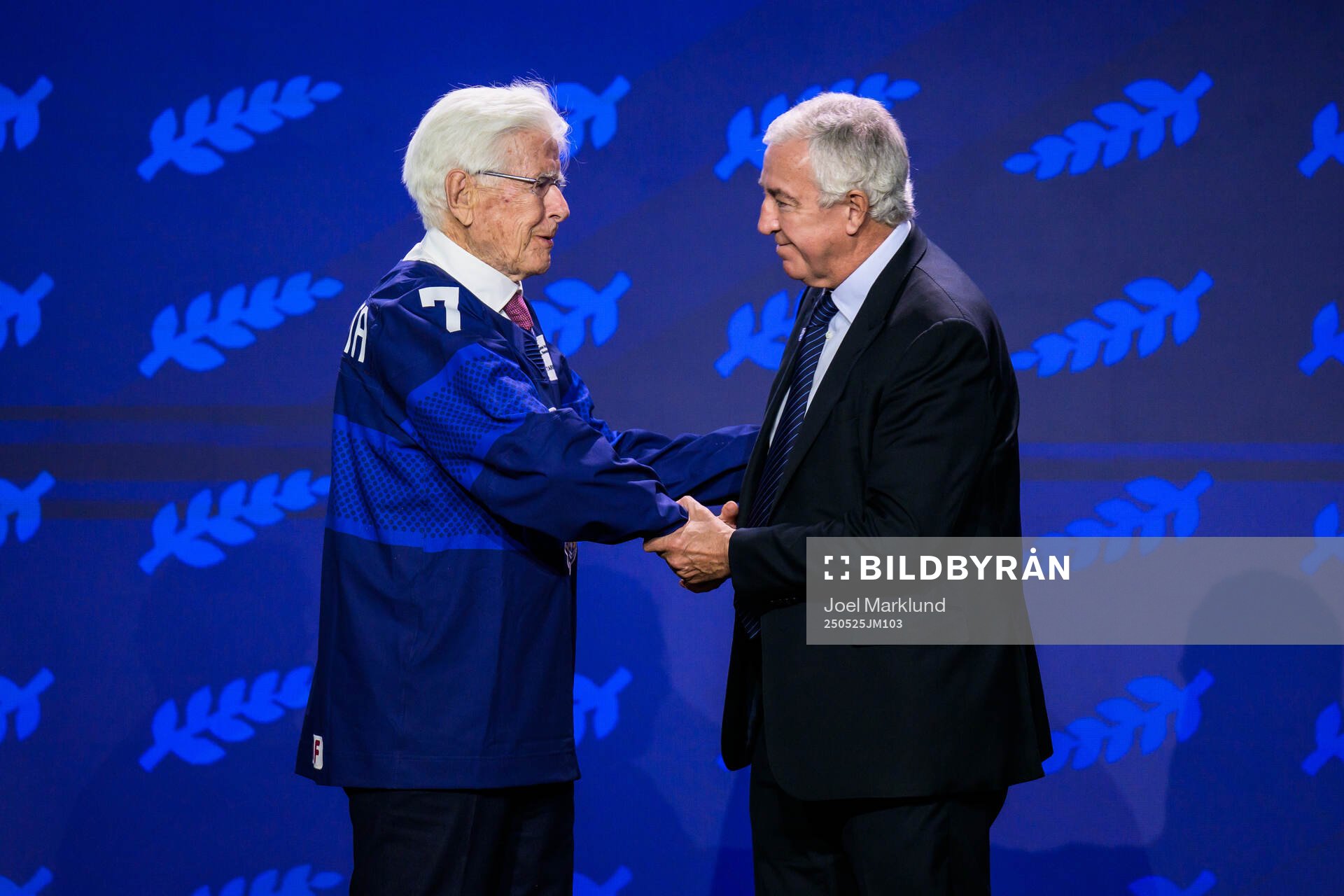 Kai Hietarinta of Finland and IIHF president Luc Tardif