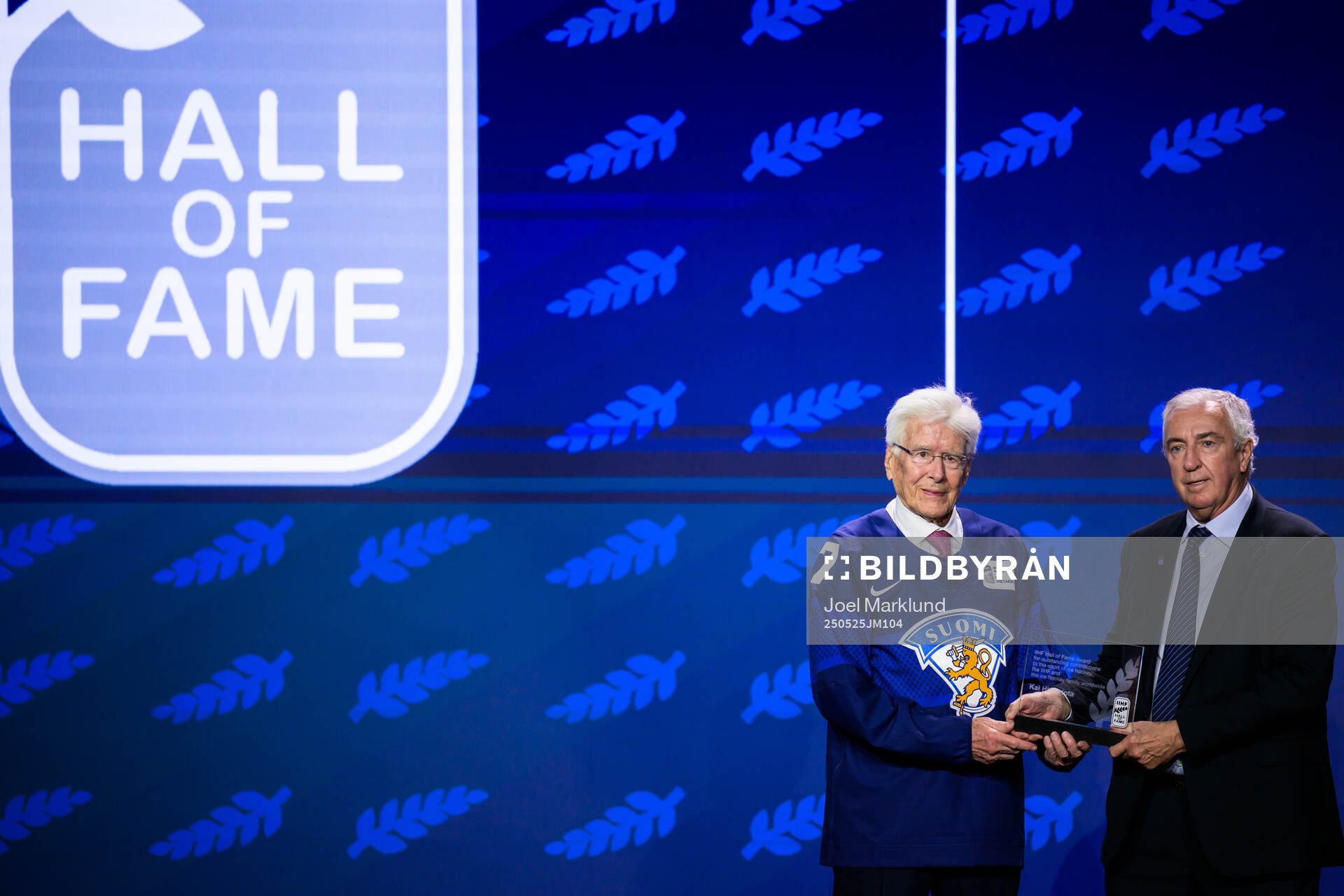 Kai Hietarinta of Finland and IIHF president Luc Tardif