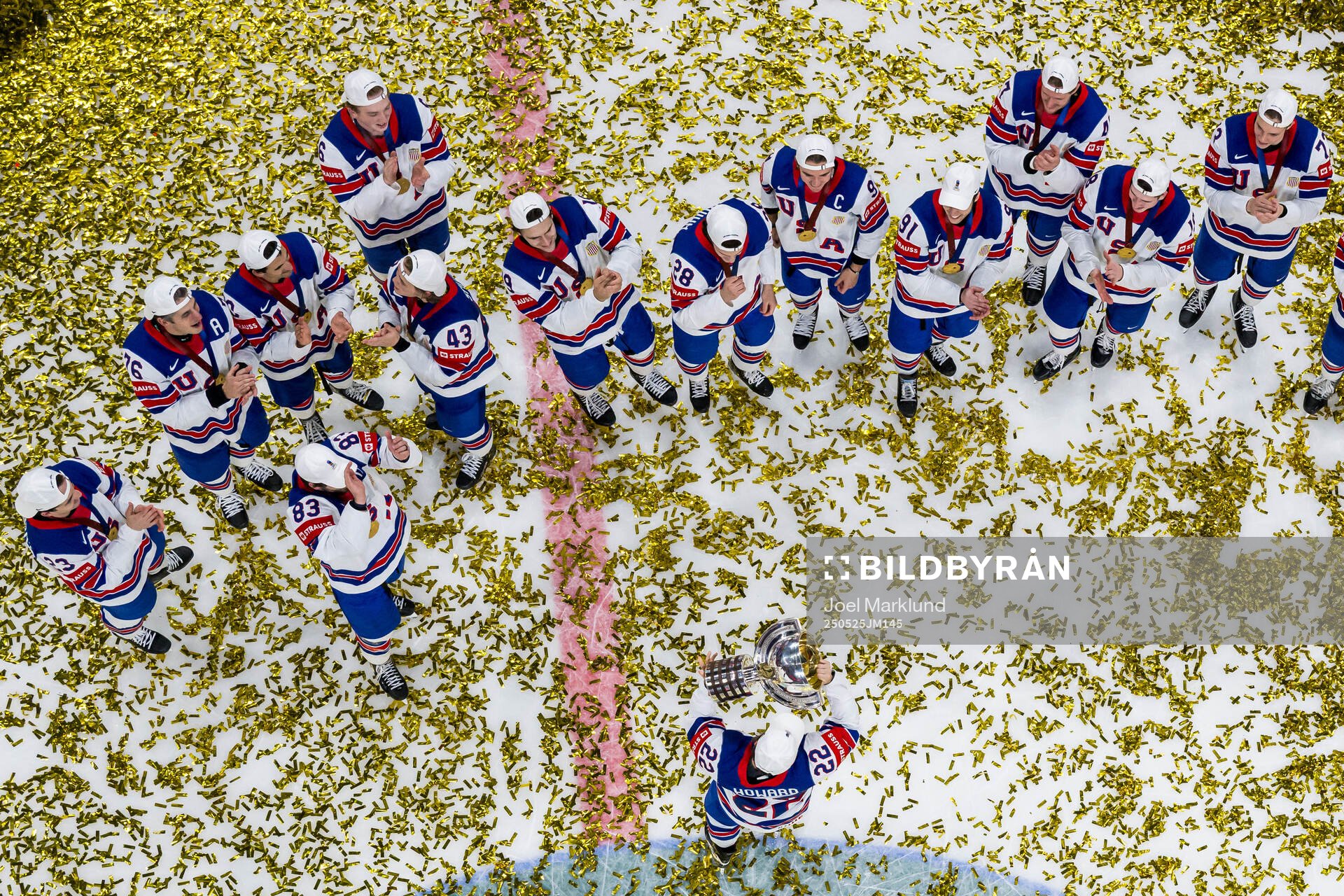 Isaac Howard of USA celebrates with the trophy in front of