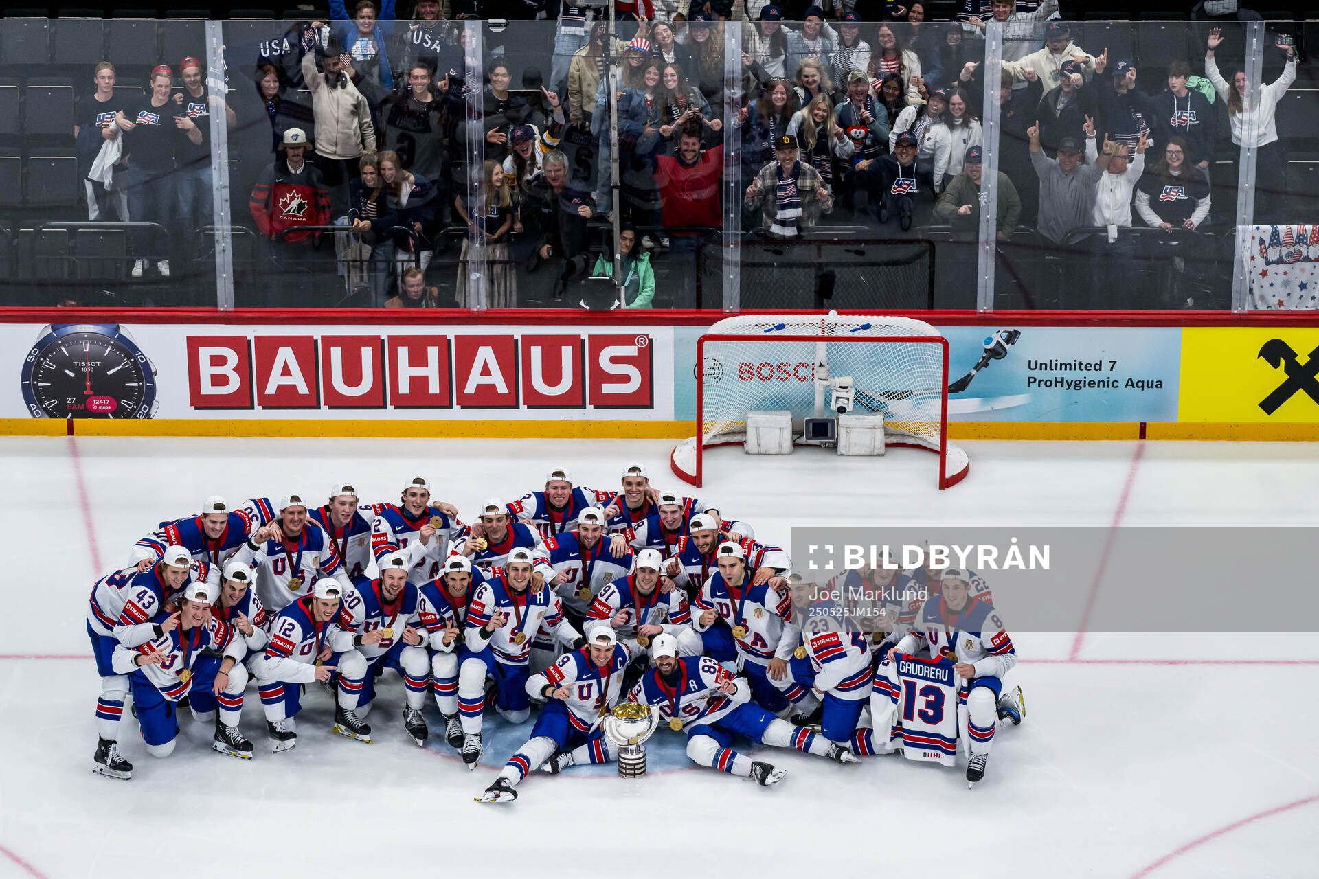 Players of USA celebrate with the trophy in front of team