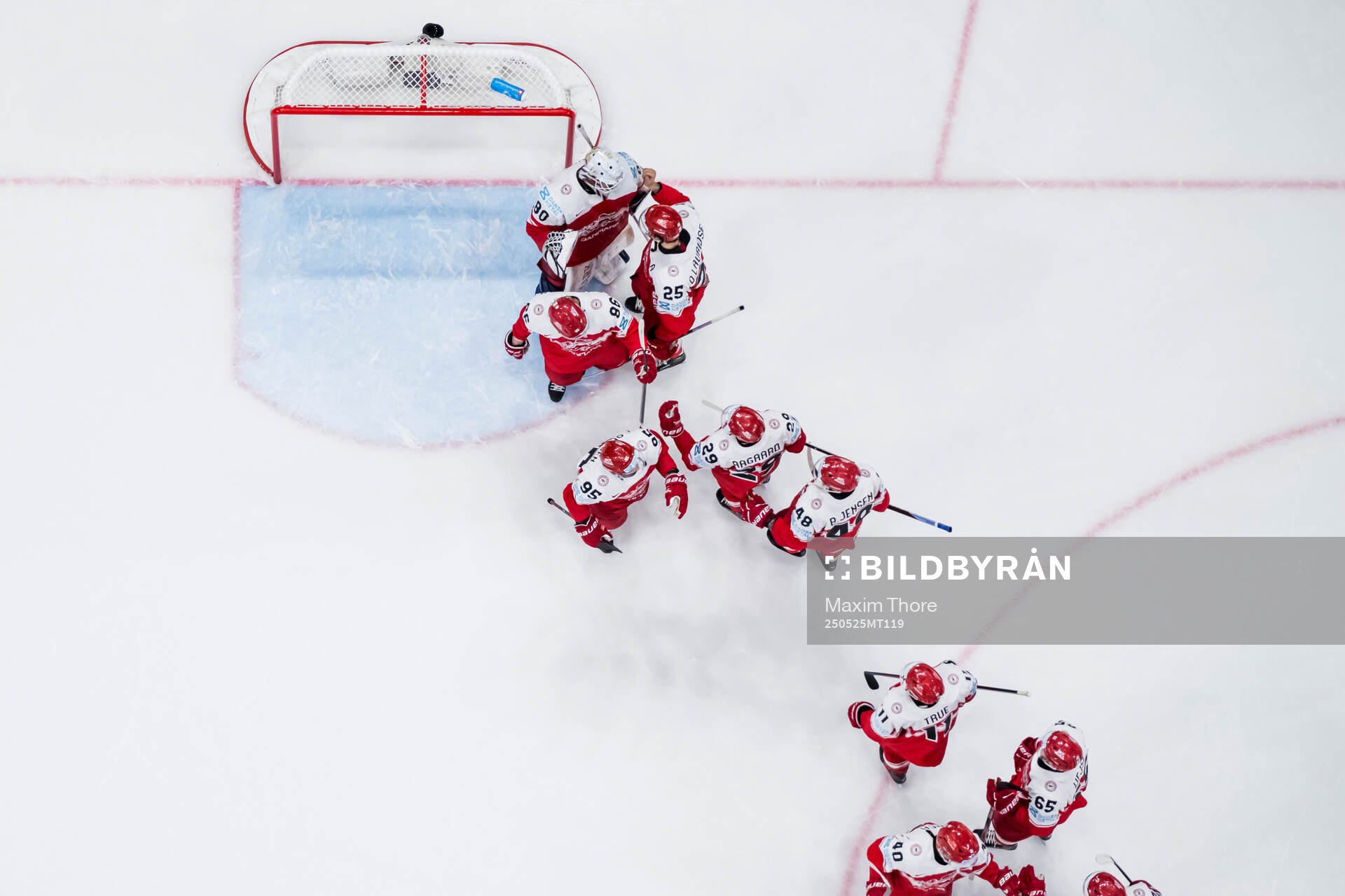 Goaltender Frederik Dichow of Denmark thank his teammates