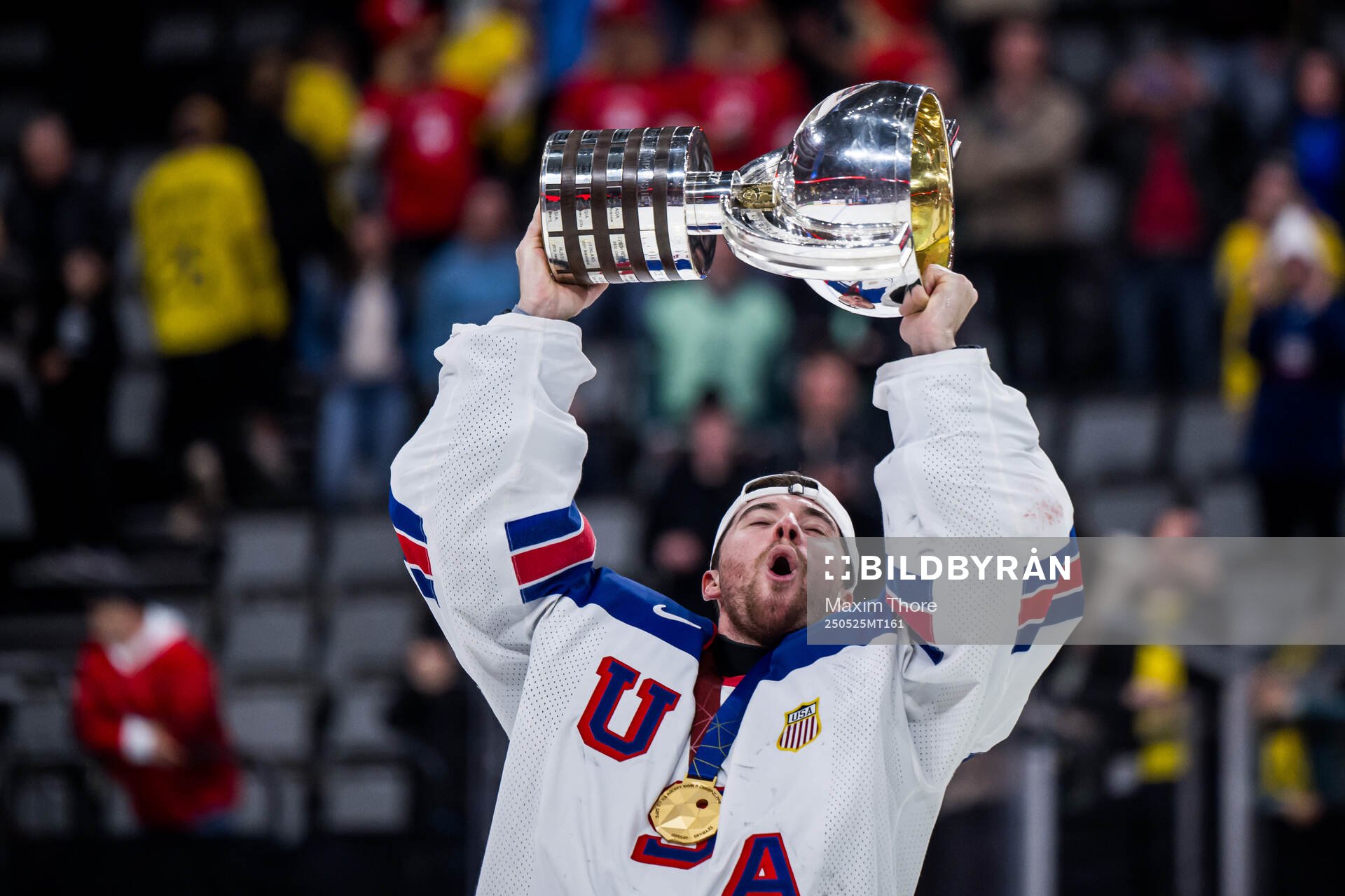Goaltender Jeremy Swayman of USA celebrates with t he trophy