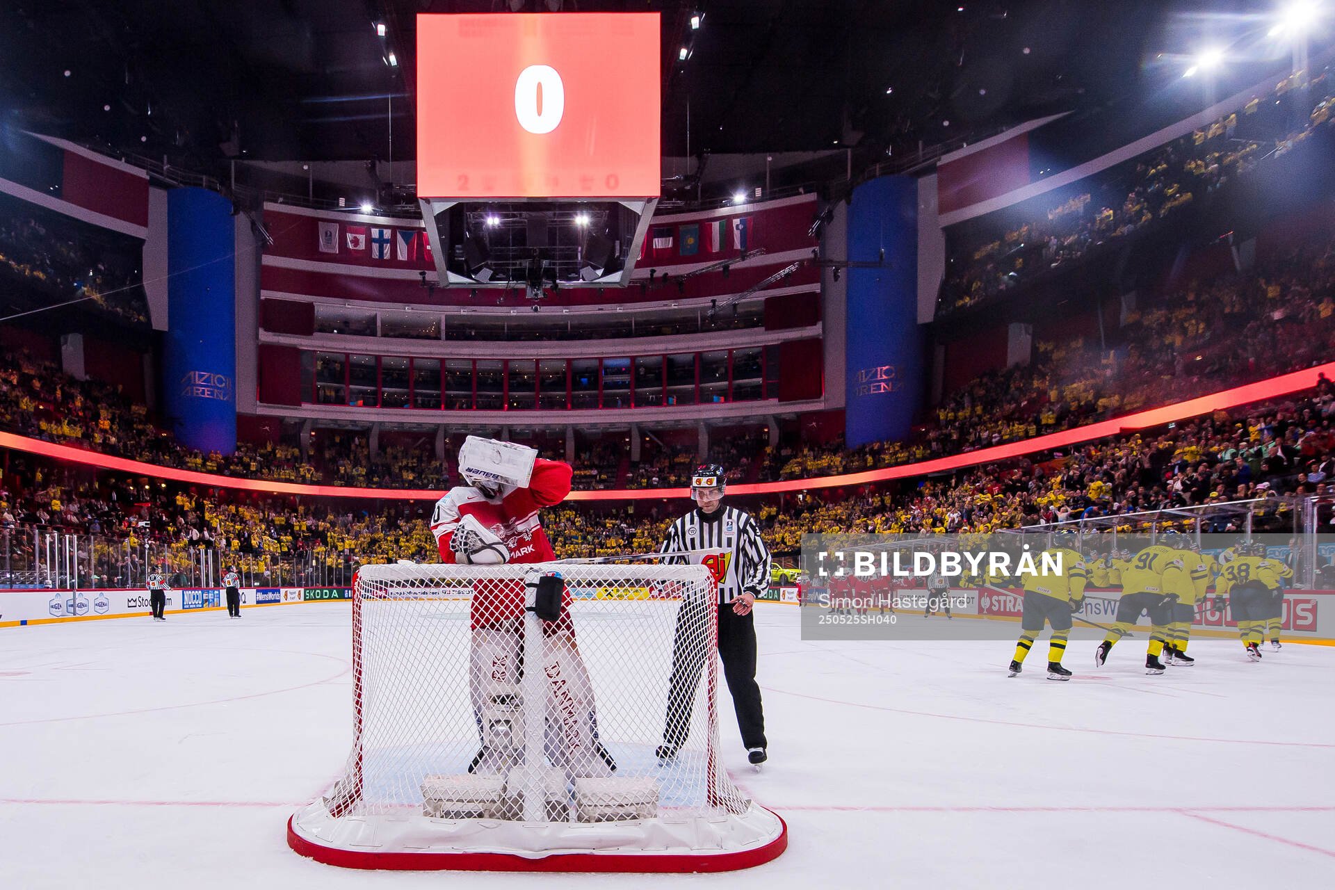 Goaltender Frederik Dichow of Denmark looks dejected