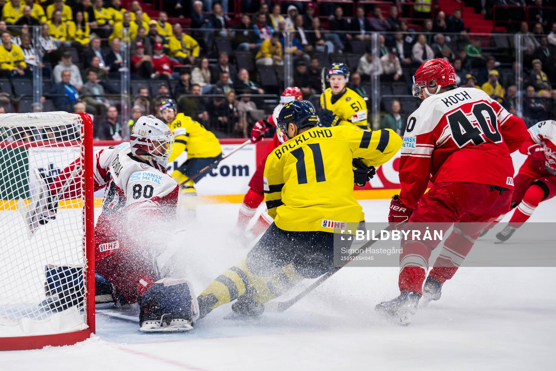 goaltender Frederik Dichow of Denmark and Mikael Backlund