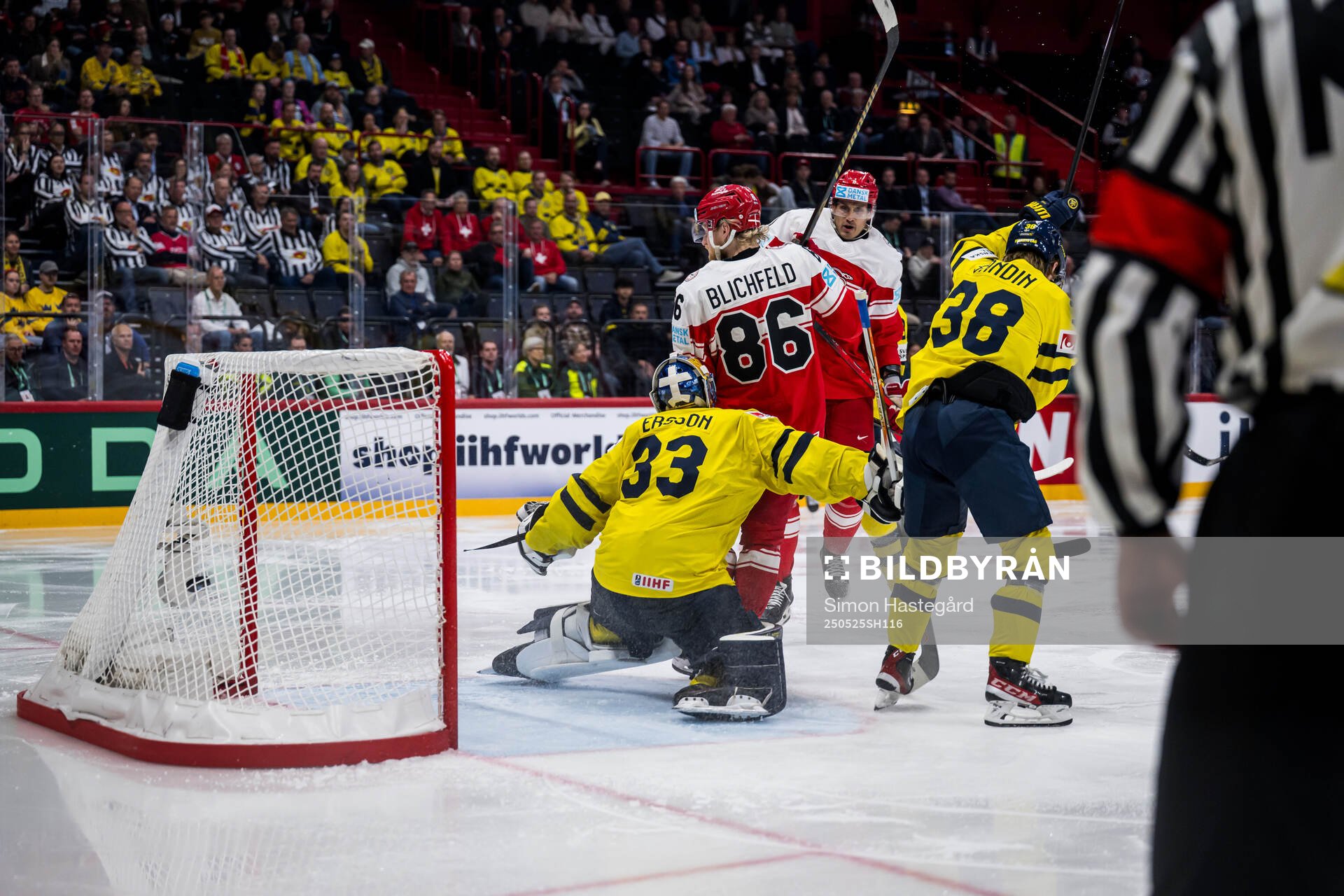 goaltender Samuel Ersson of Sweden and  Joachim Blichfeld