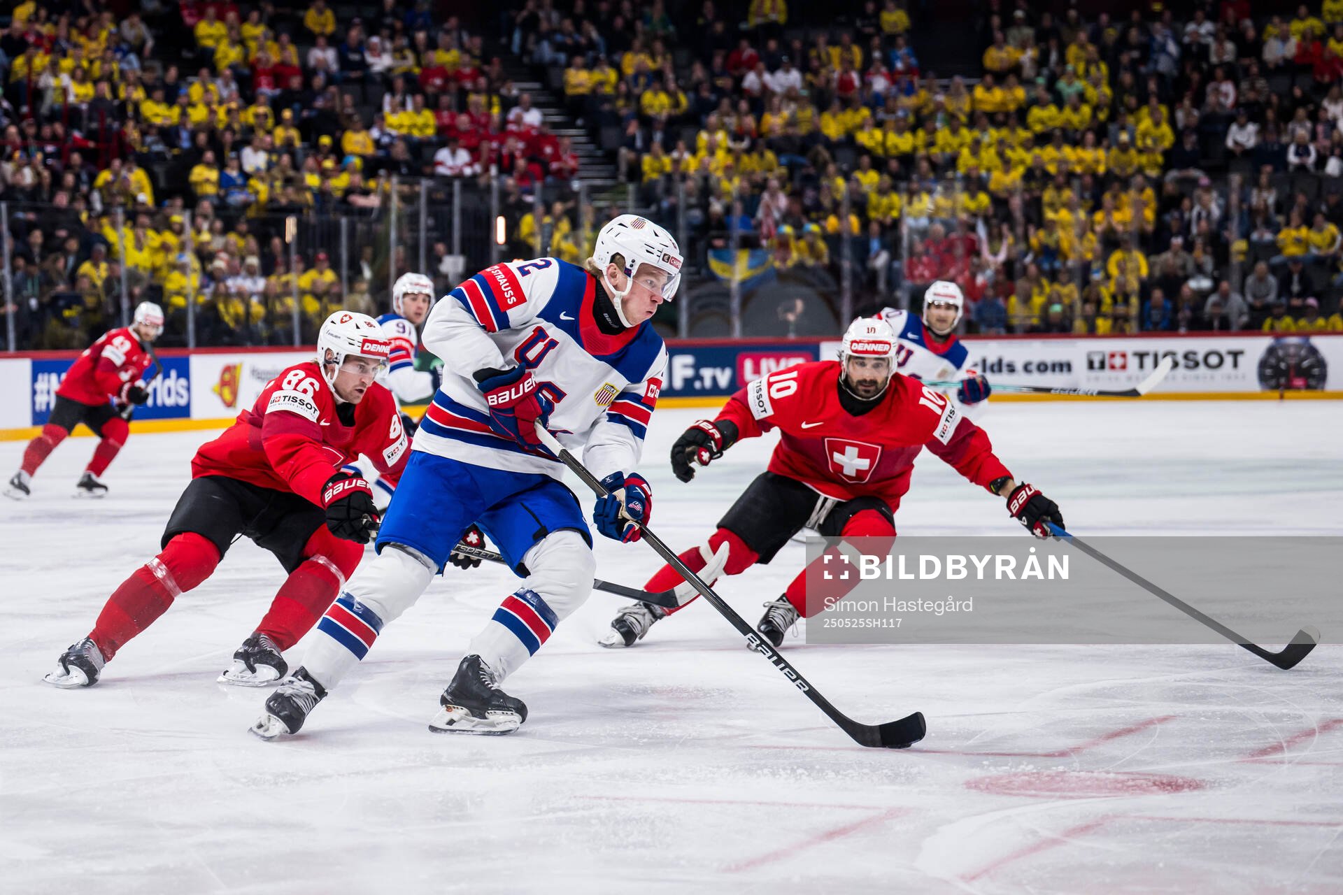 Janis Moser and Andres Ambuhl of Switzerland defend against