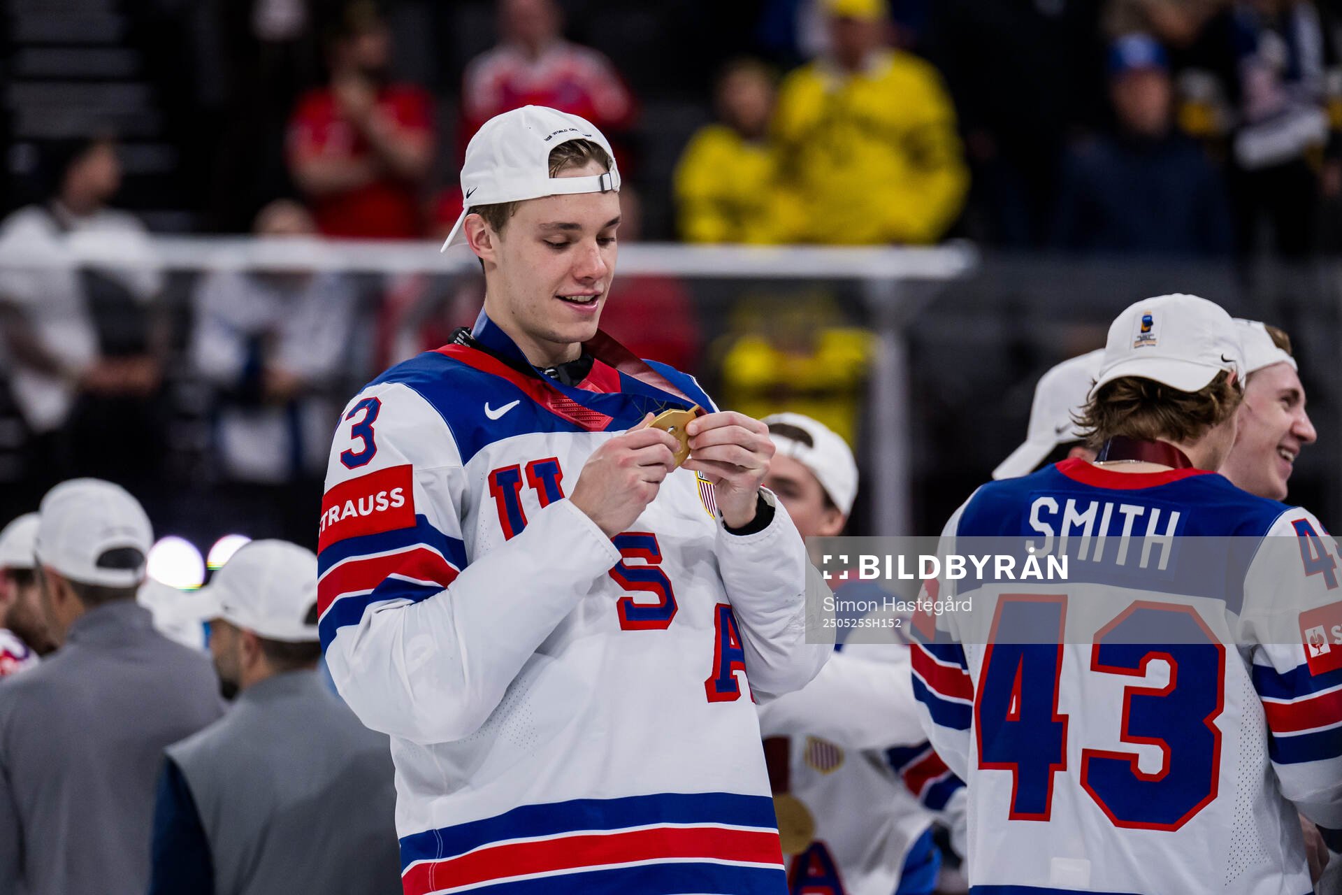 Alex Vlasic celebrates with his gold medal