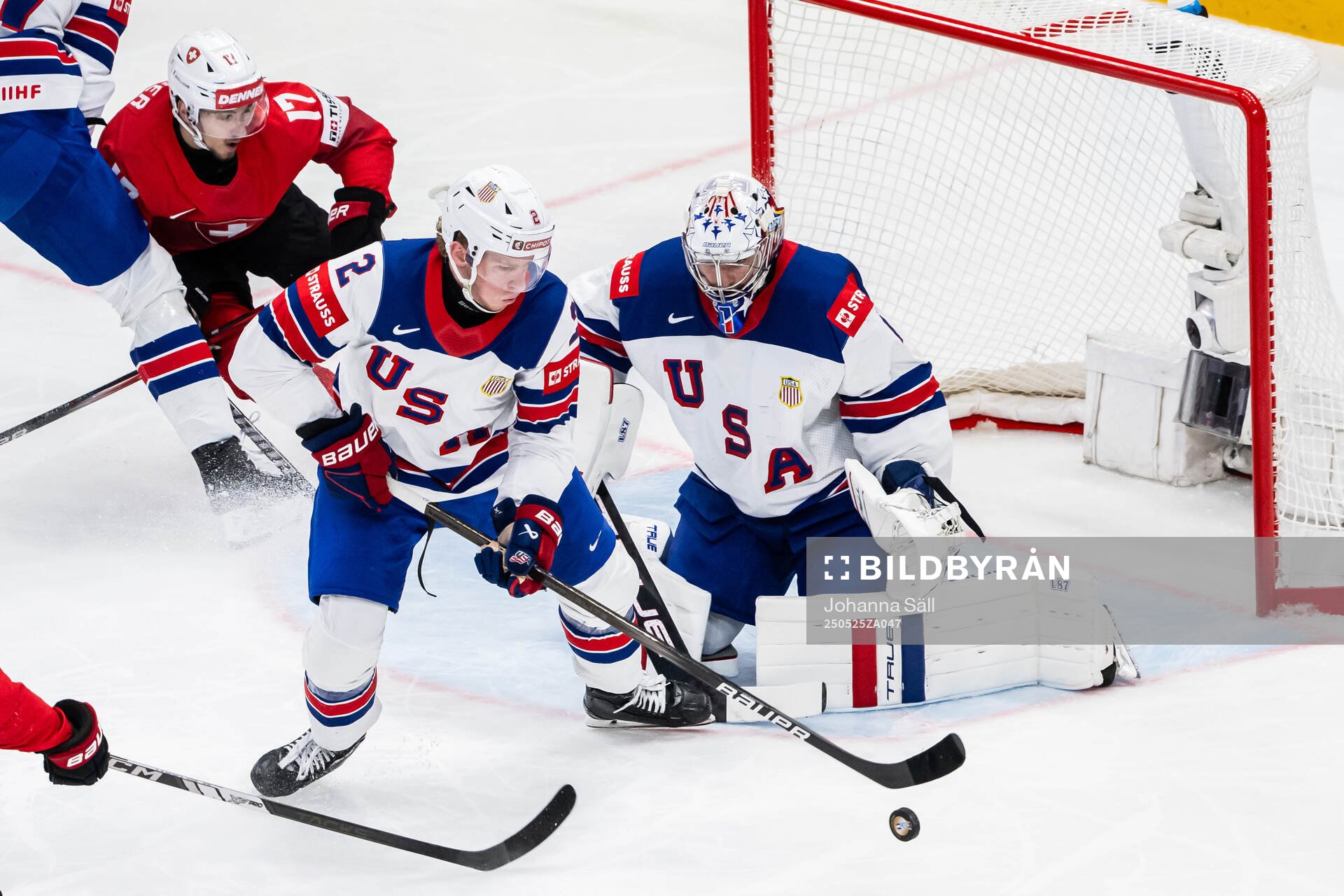 Jackson LaCombe and goaltender Jeremy Swayman of USA