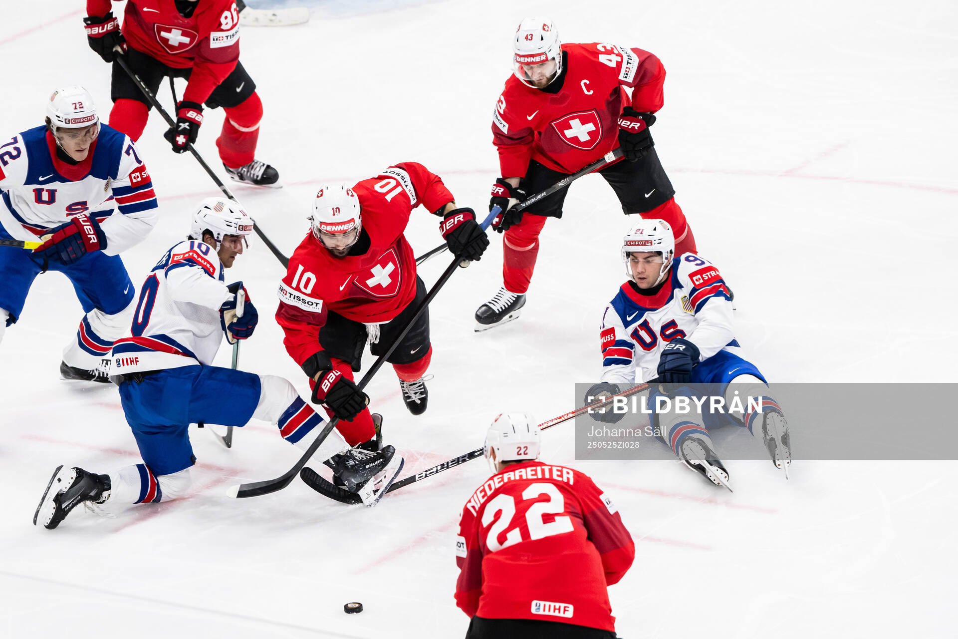 Matty Beniers and Frank Nazar of USA against Andres Ambuhl