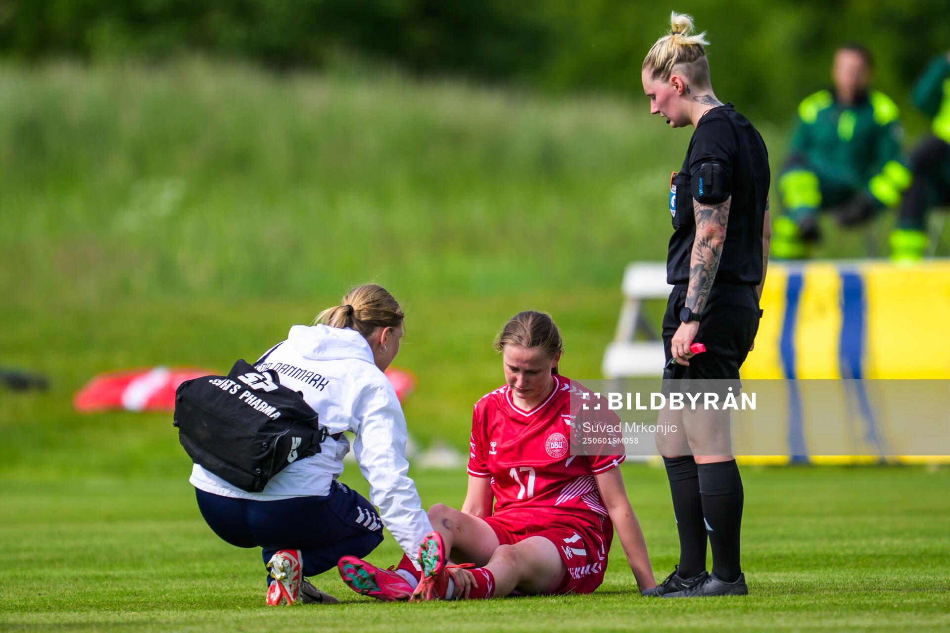 Andrea Thierry of Denmark receives medical attention by