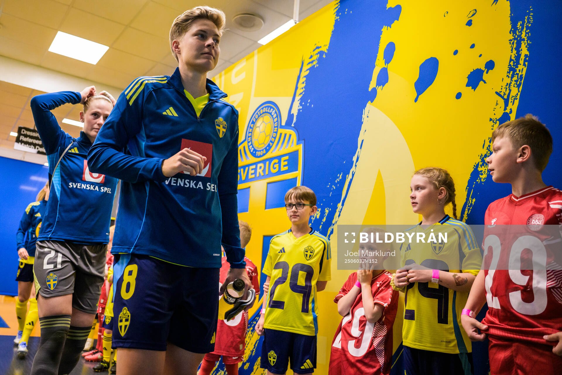 Lina Hurtig of Sweden walk by mascots in the player tunnel