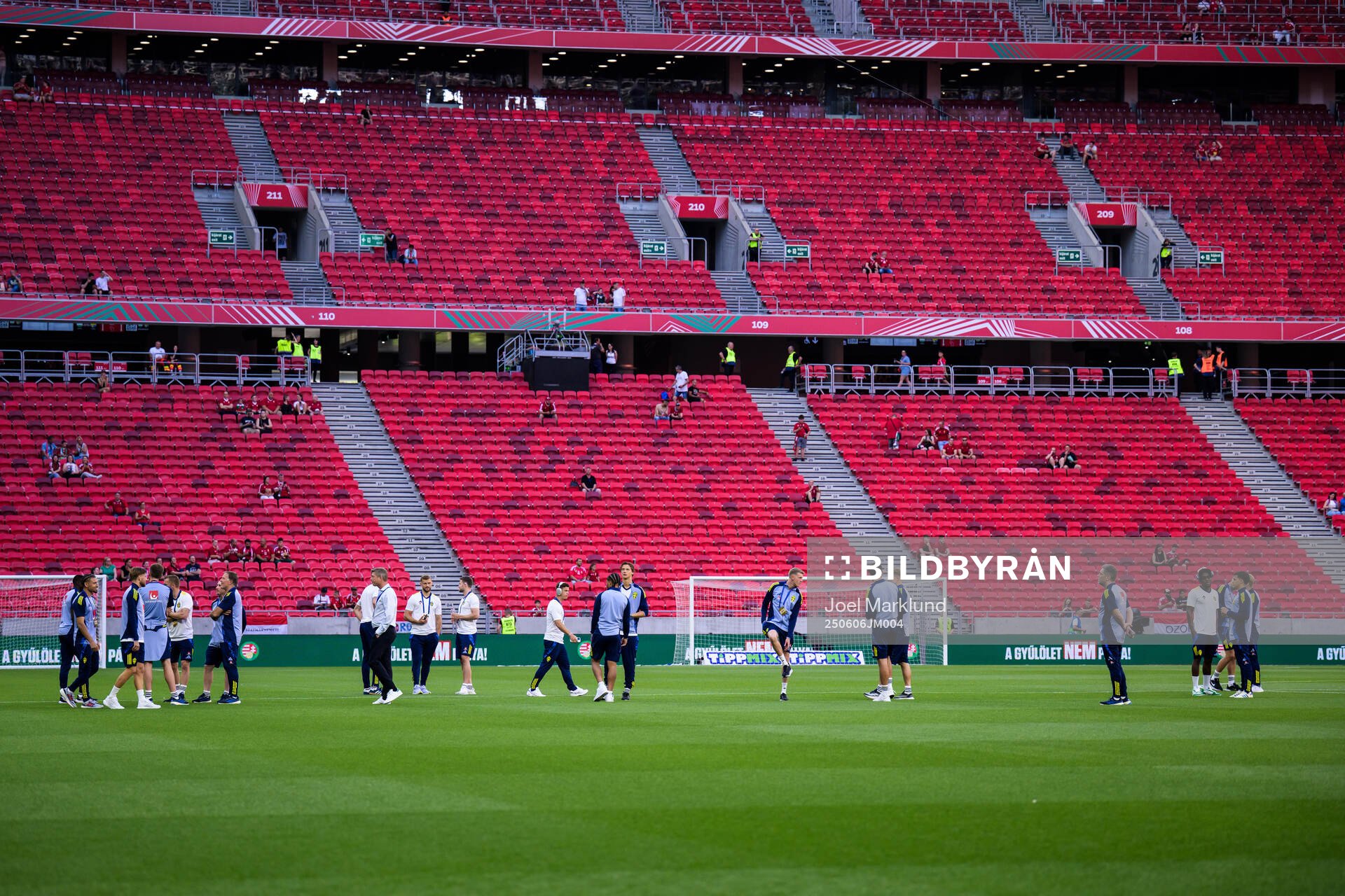 Players and coaching staff of Sweden walk the pitch