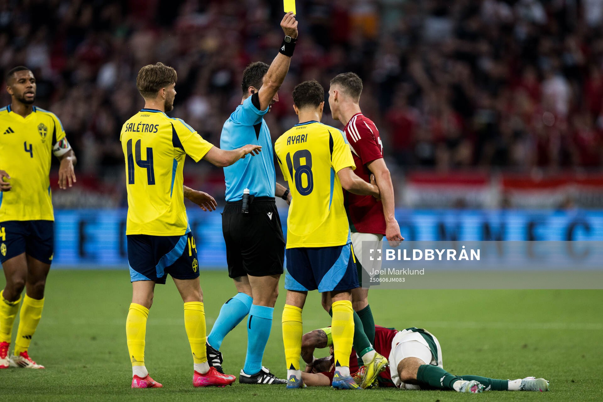 Yasin Ayari of Sweden receives a yellow card from referee