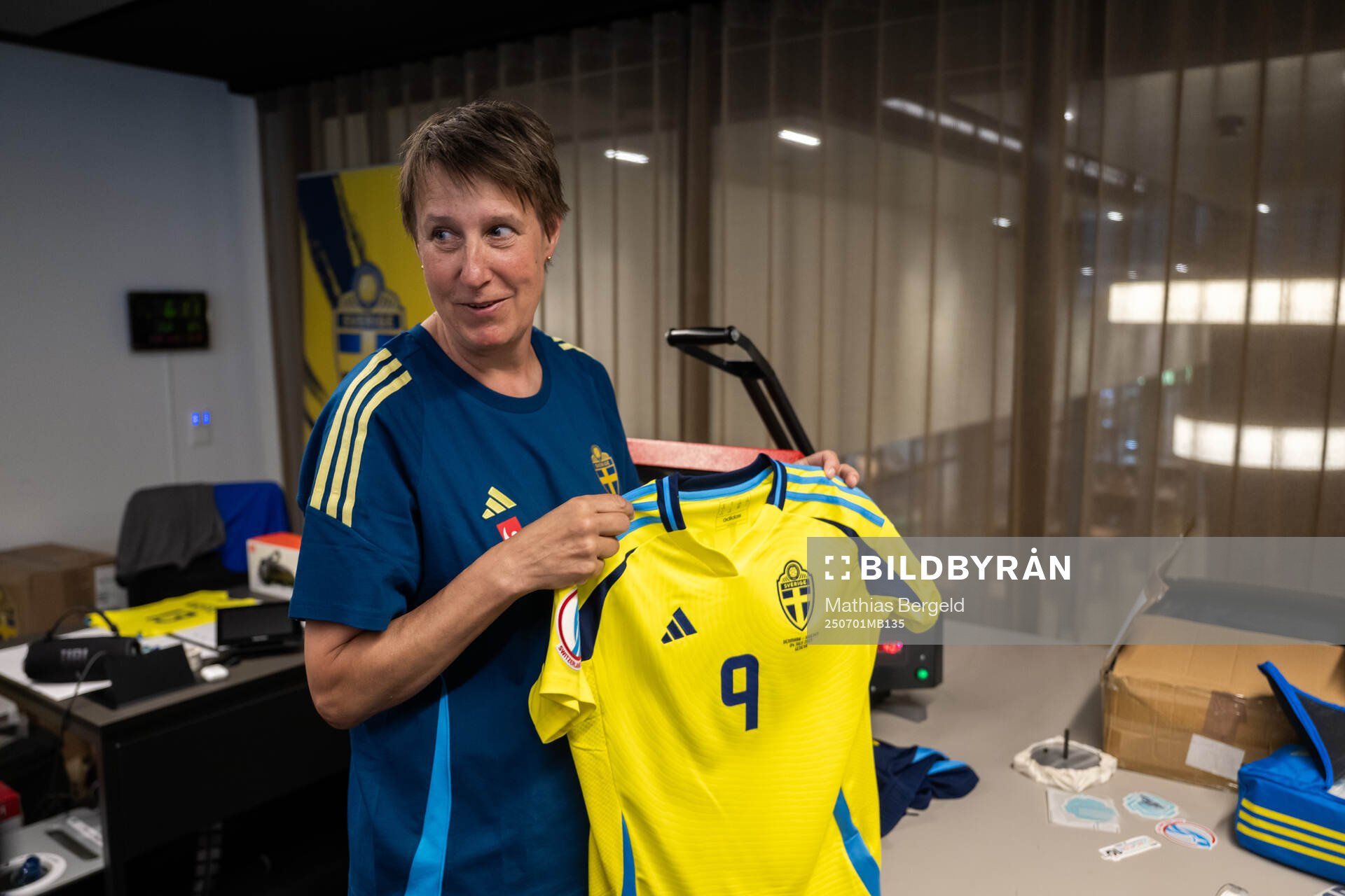 Equipment manager Jessica Karlsson holds the match shirt of