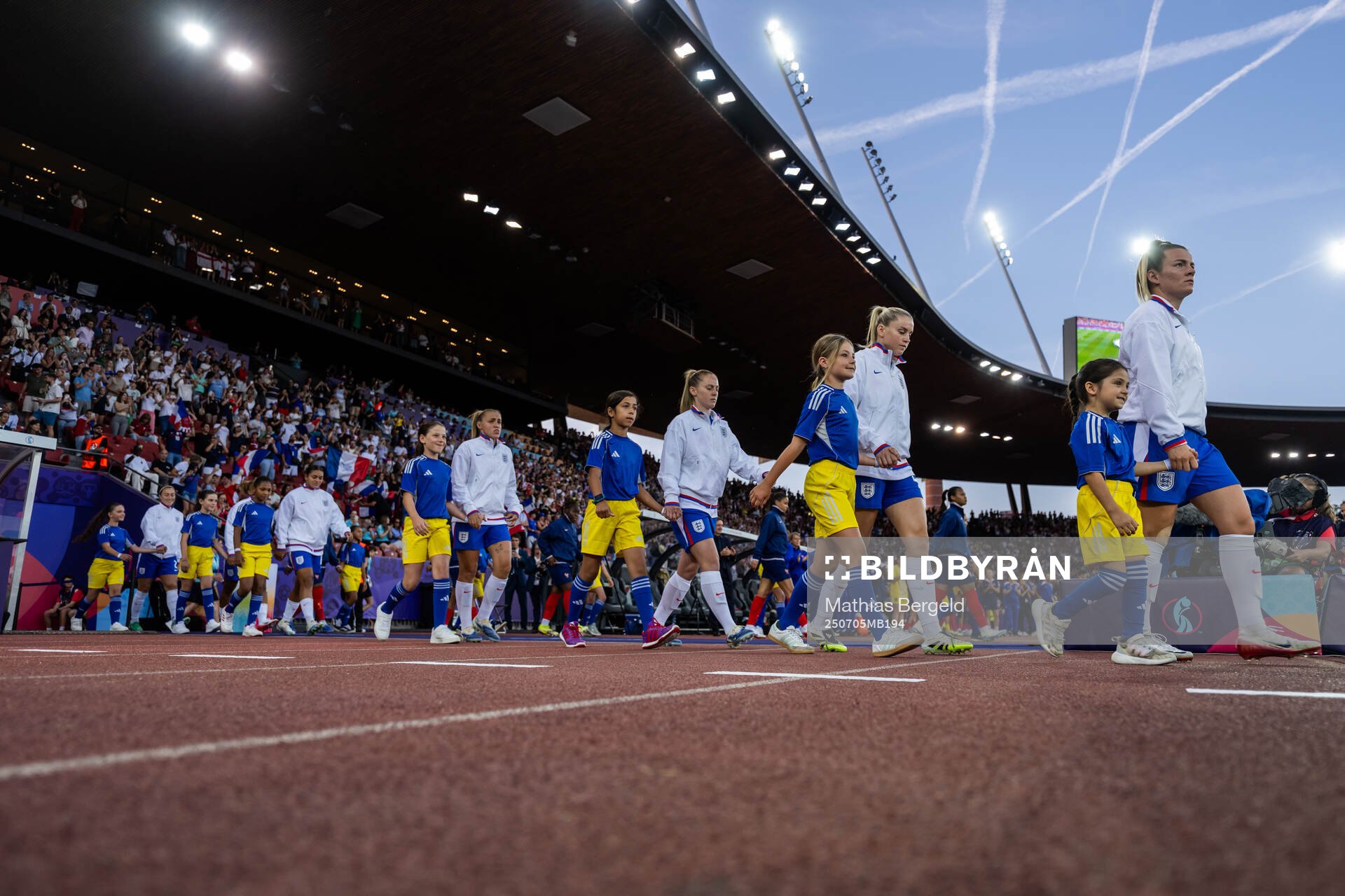 Players of England and of France enter the arena