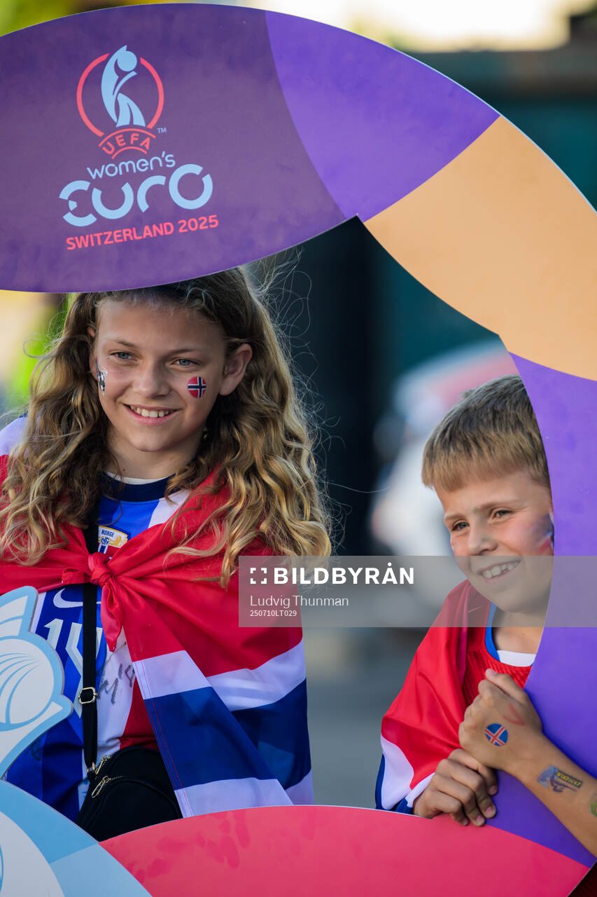 Two young children with face painting and with the flag of