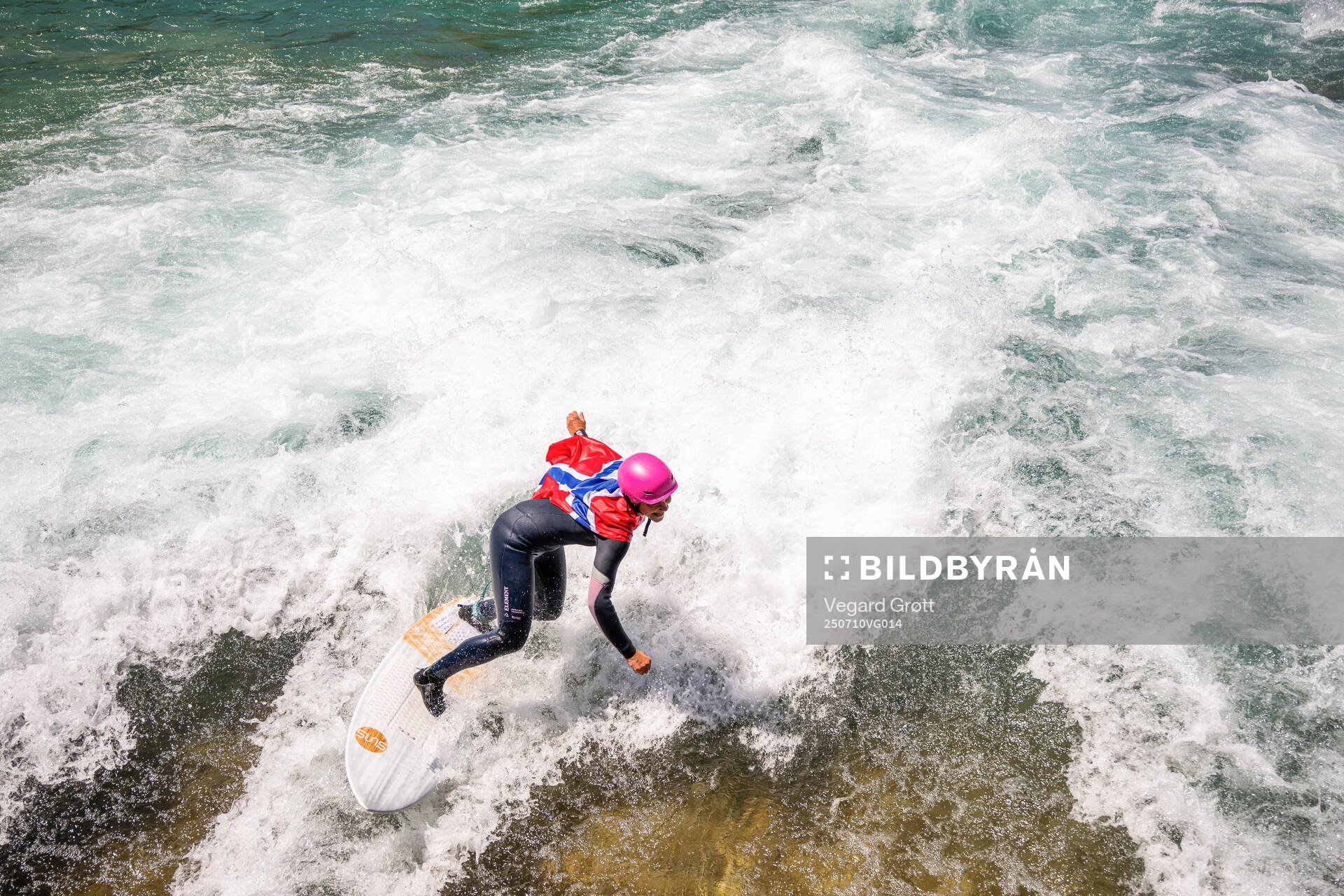 A surfer with a Norwegian flag