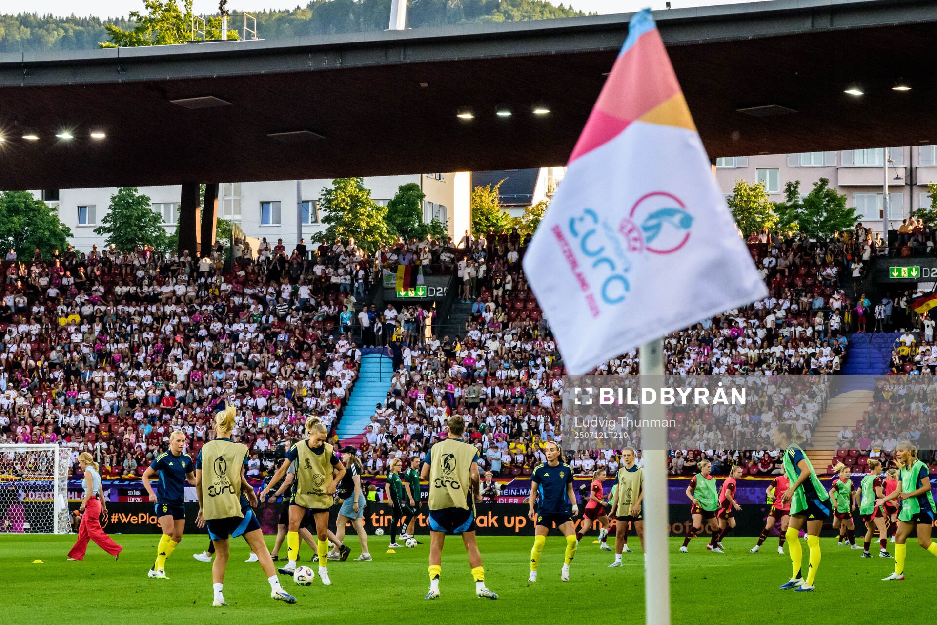 Players of Sweden varm up behind the flag for the UEFA