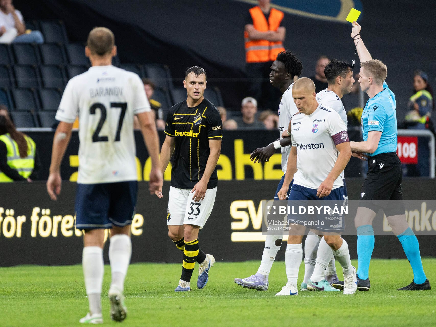 Áron Csongvai of AIK is shown a yellow card by referee