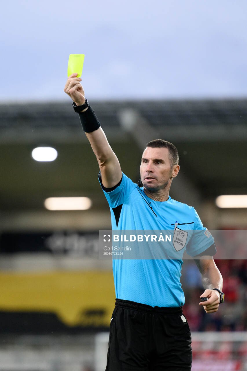 Referee Georgi Kabakov shows a yellow card