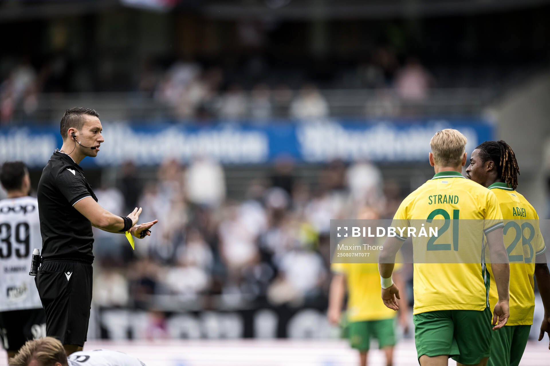 Referee Zorbay Kucuk and Simon Strand of Hammarby