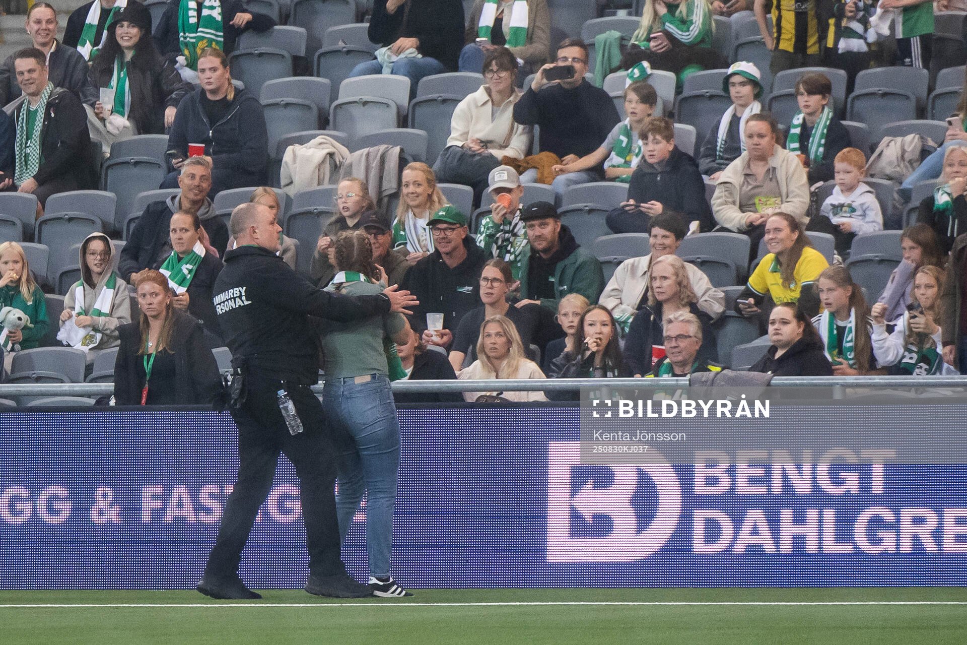 A security guard removes a spectator